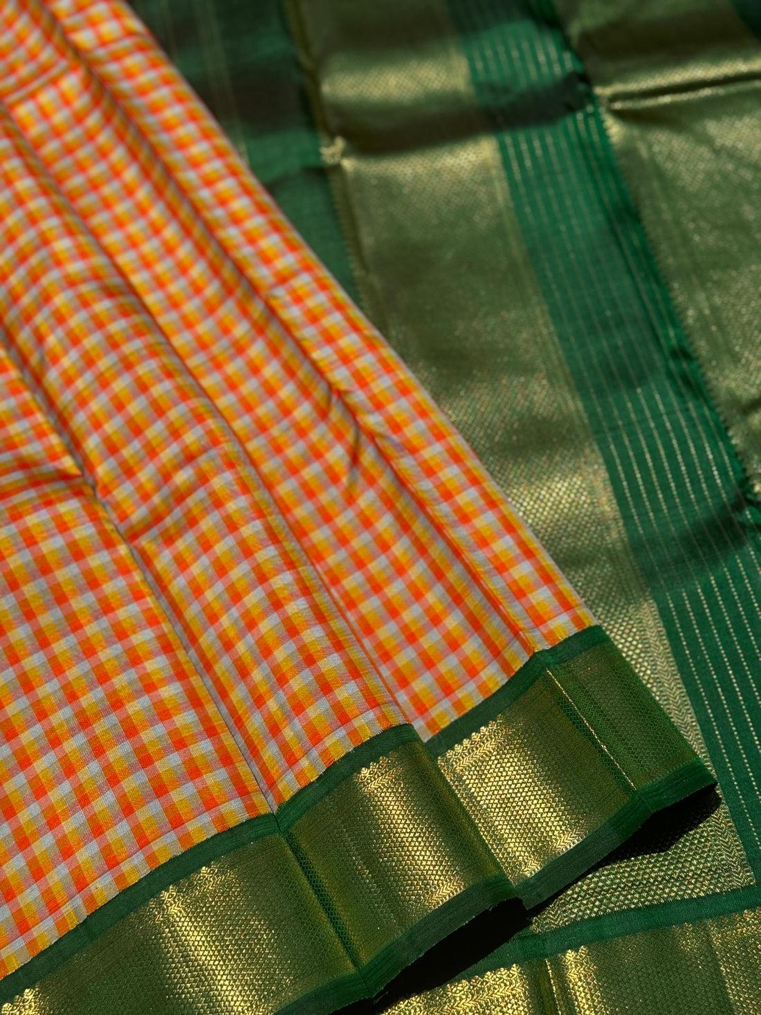 The stunner pastel orange and yellow checks with green shade korvai kanchivaram silk saree