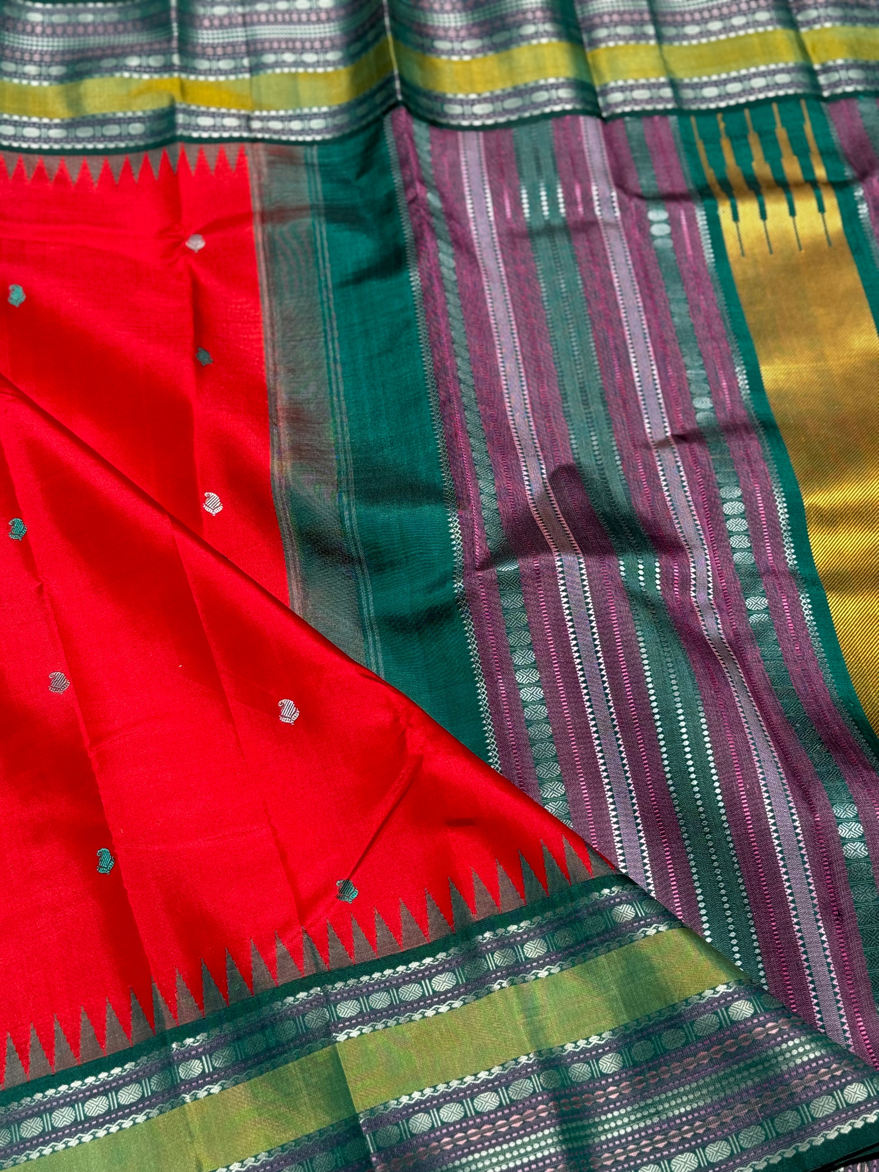 The stunner tomato red with green shade korvai kanchivaram silk saree with thread work korvai