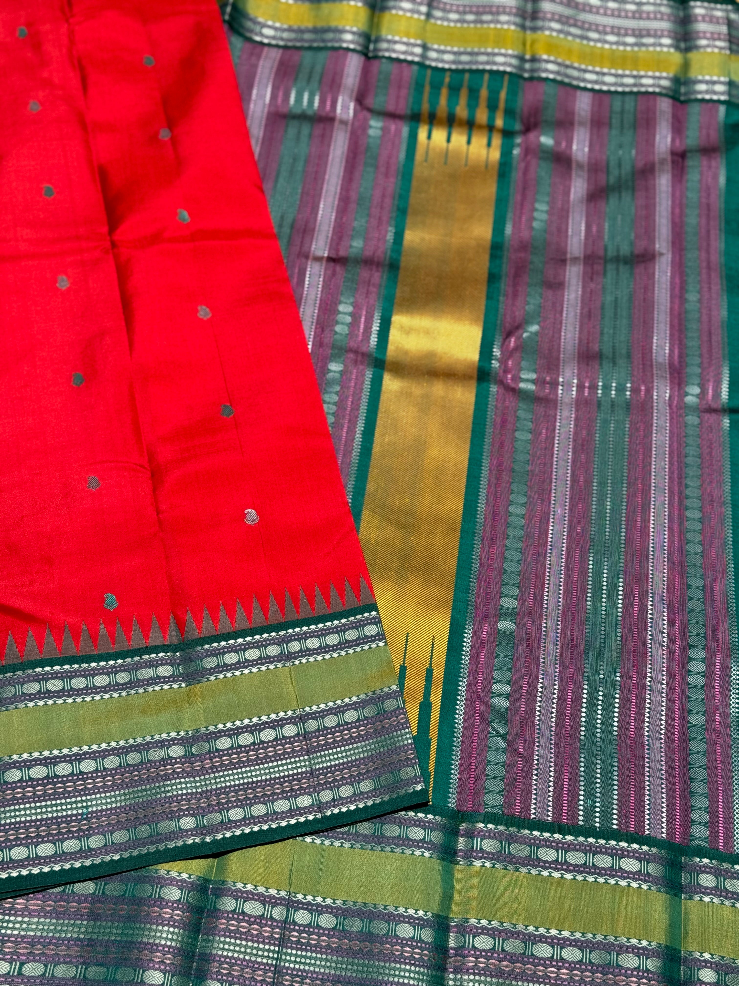 The stunner tomato red with green shade korvai kanchivaram silk saree with thread work korvai