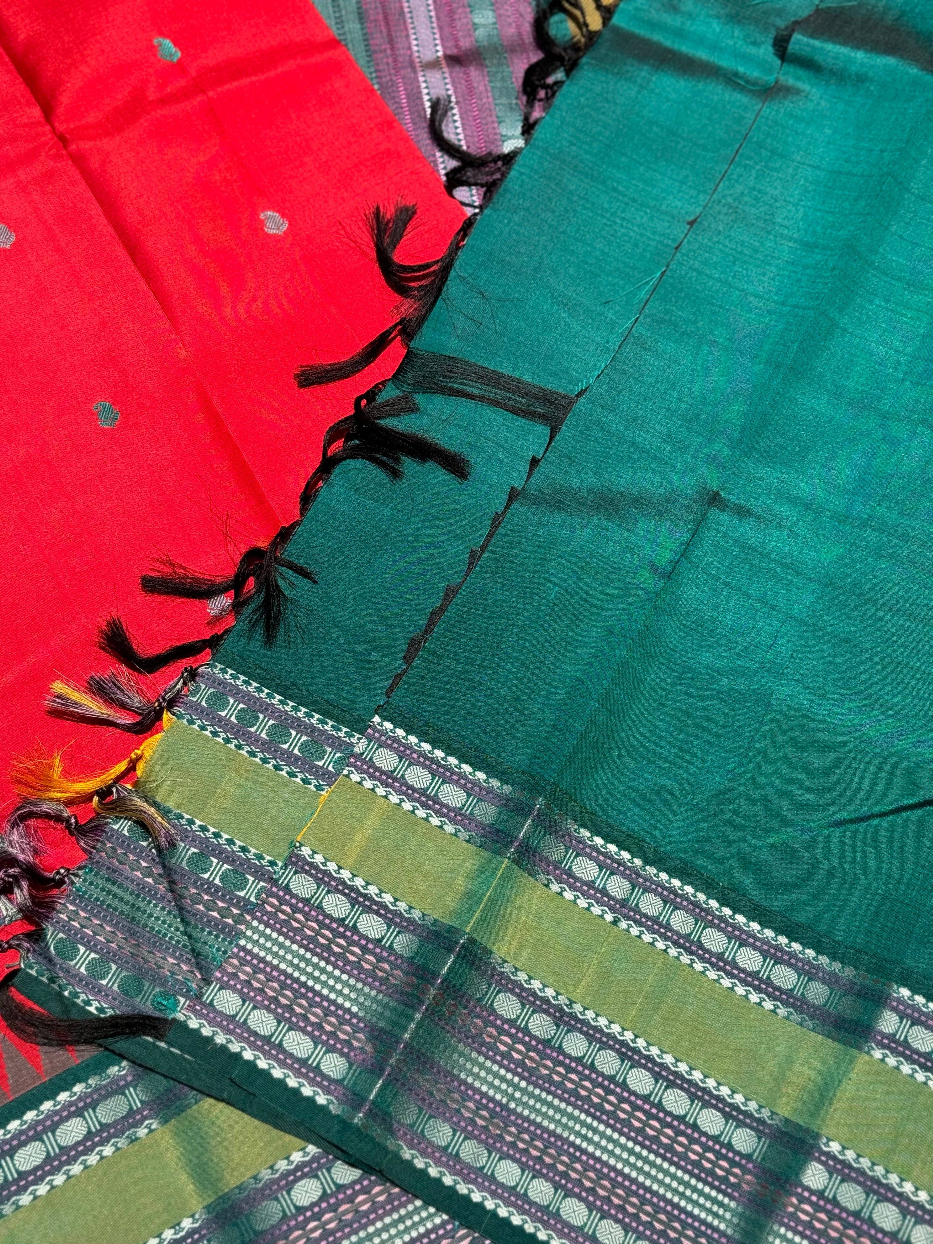 The stunner tomato red with green shade korvai kanchivaram silk saree with thread work korvai