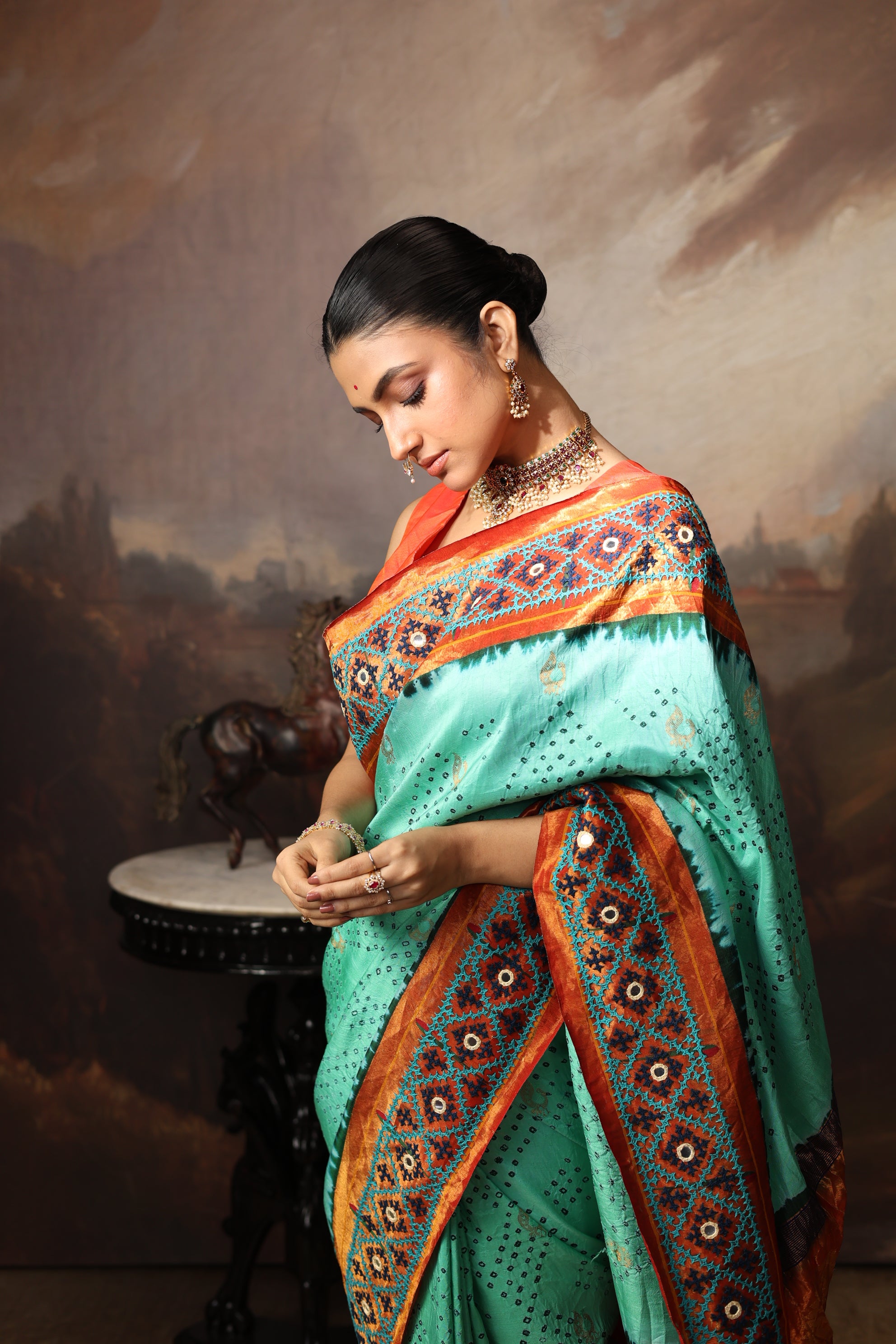 Intricate art piece blending Paithani Muniya with hand-knotted Bhandej and embellished with Kutch mirror work border