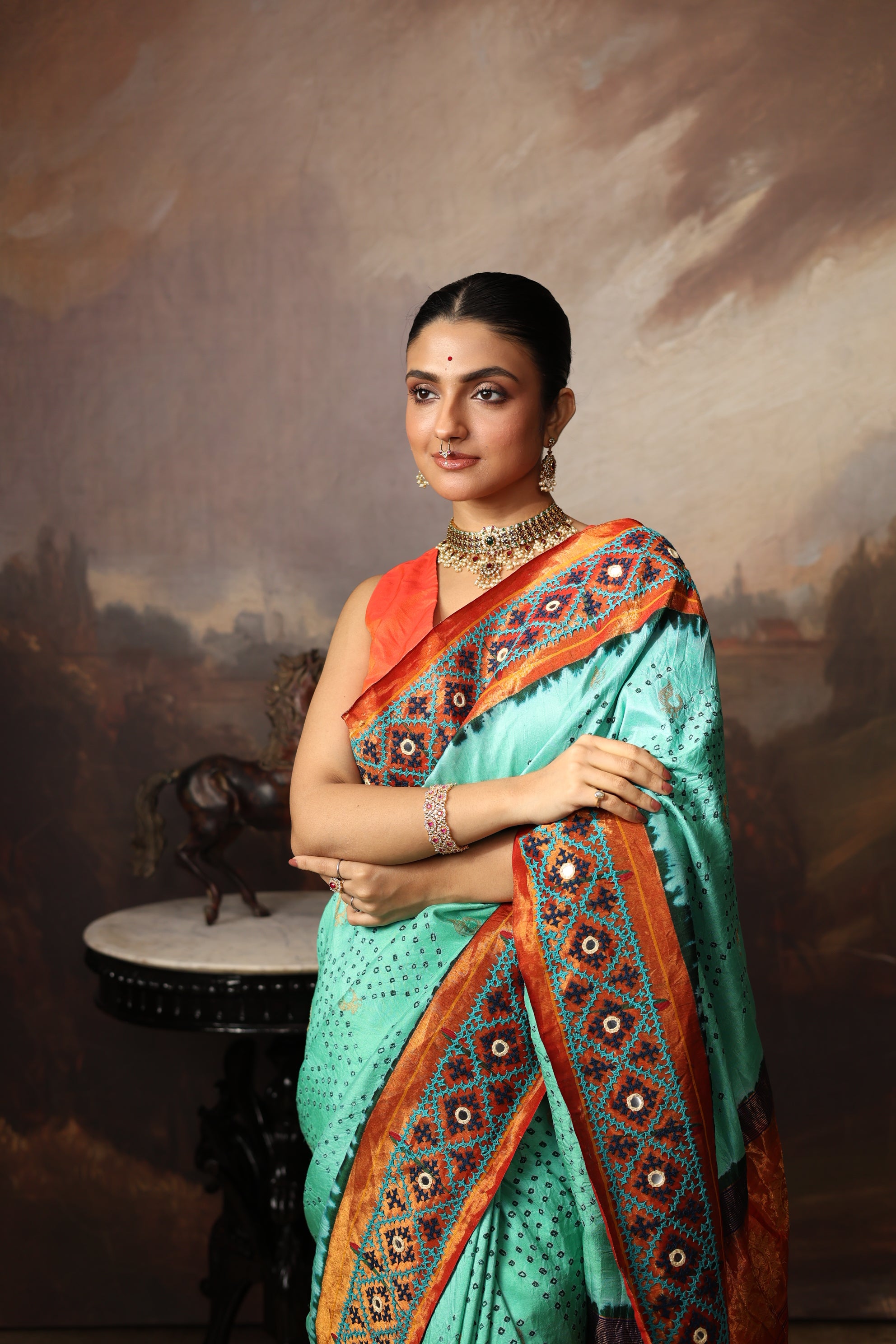 Intricate art piece blending Paithani Muniya with hand-knotted Bhandej and embellished with Kutch mirror work border