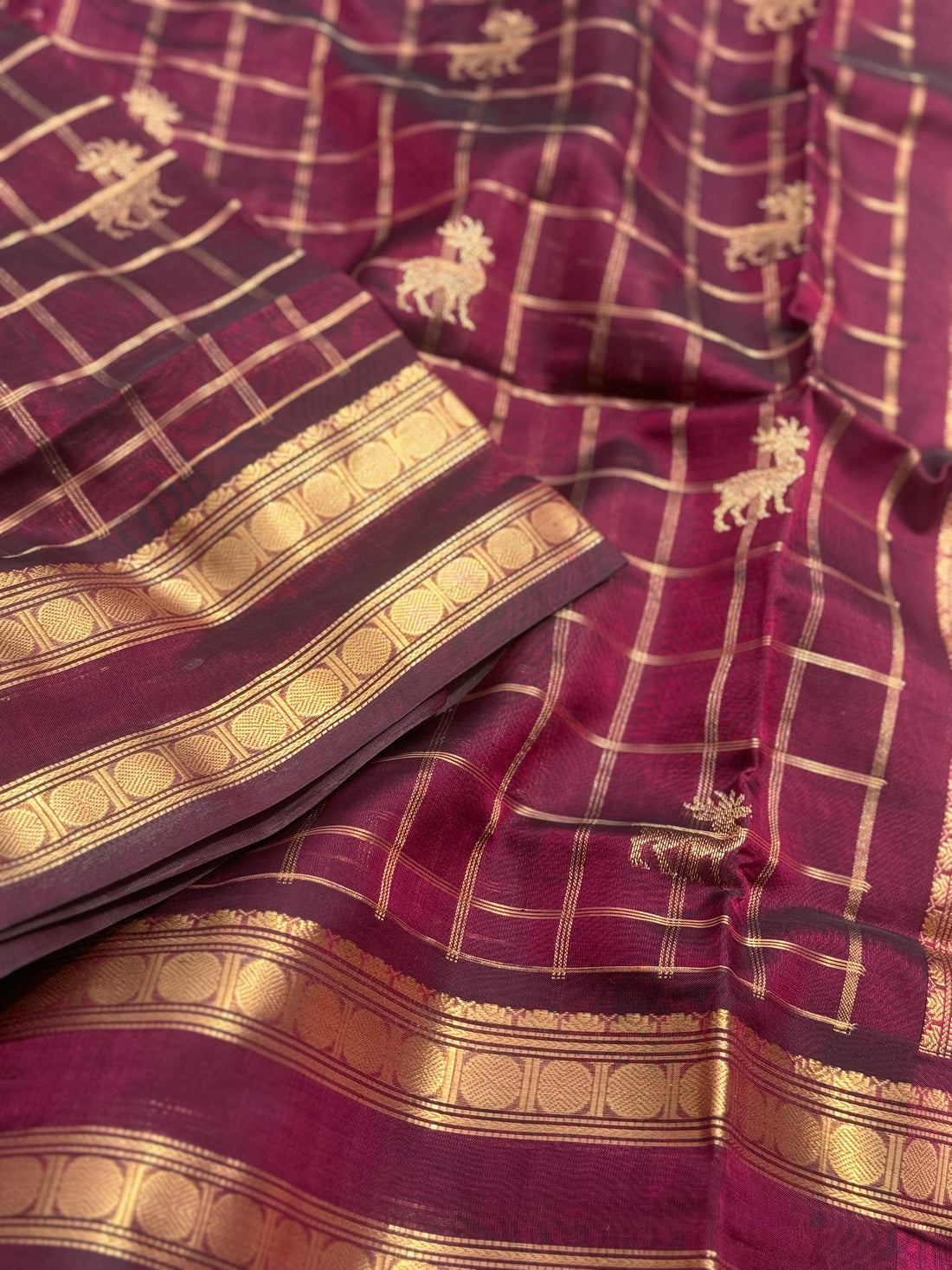 A gorgeous burgundy shade handwoven zari checks with deer motifs Kanchi silk cotton saree