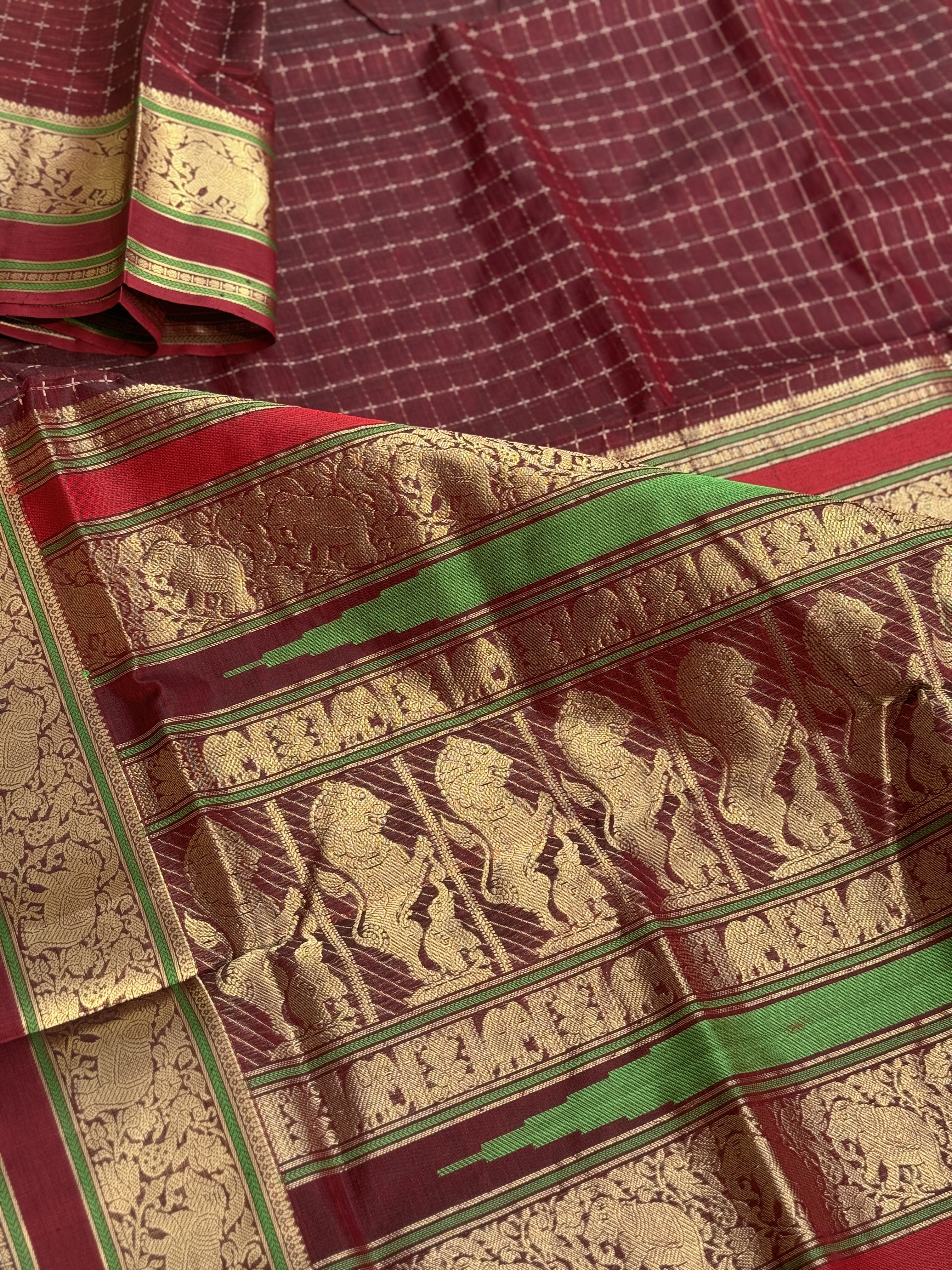 A gorgeous burgundy shade handwoven plus buttas silk cotton saree