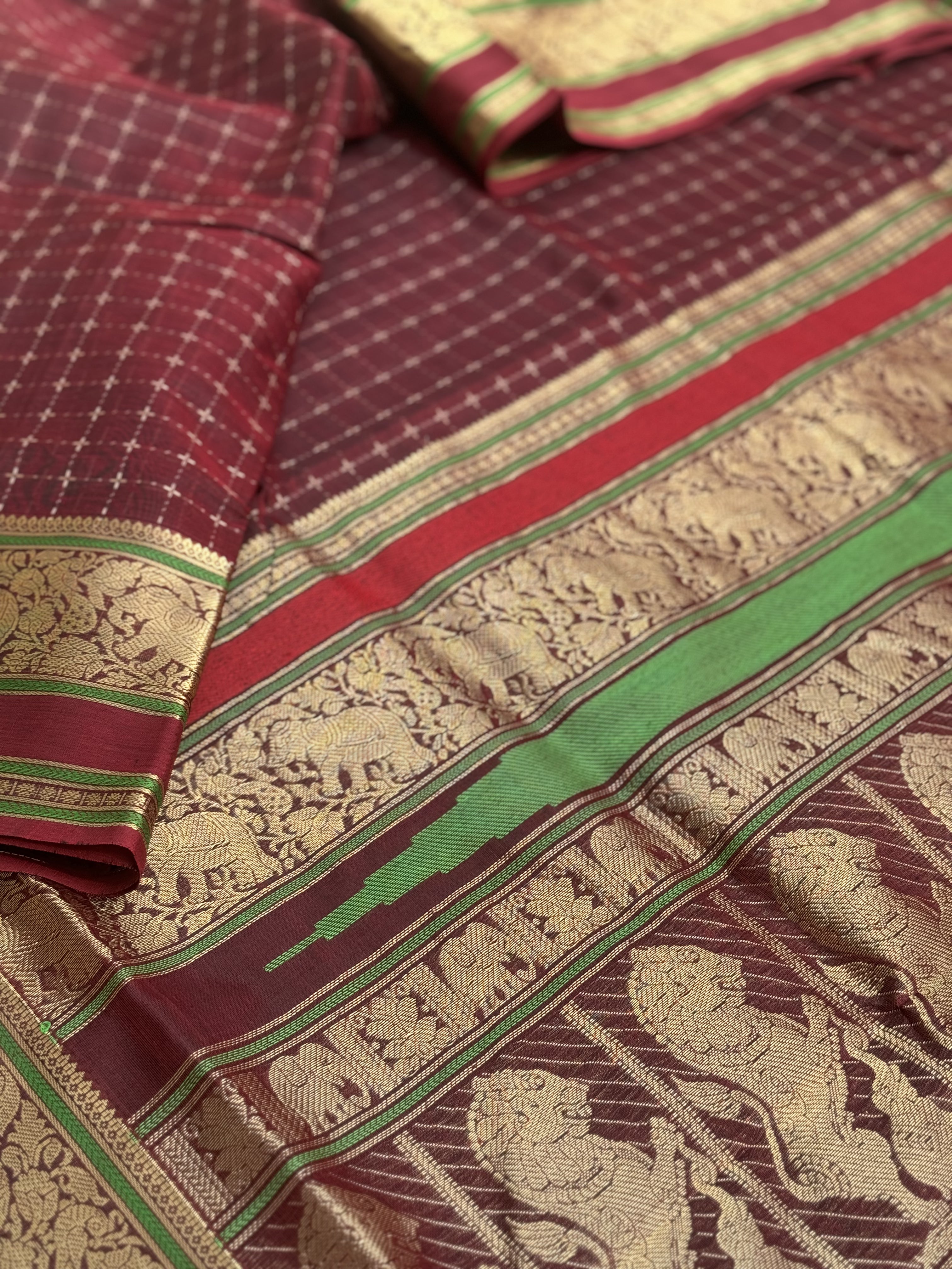 A gorgeous burgundy shade handwoven plus buttas silk cotton saree