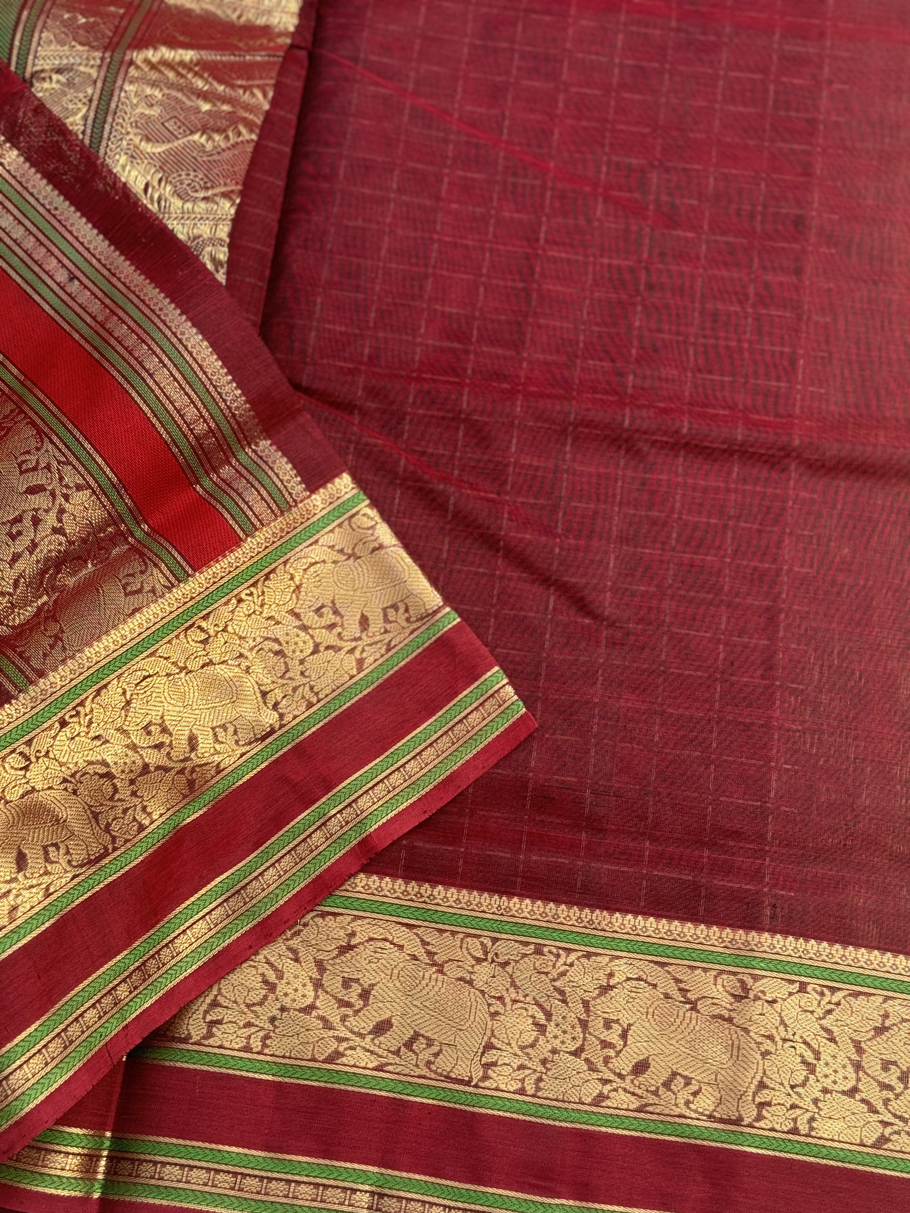 A gorgeous burgundy shade handwoven plus buttas silk cotton saree