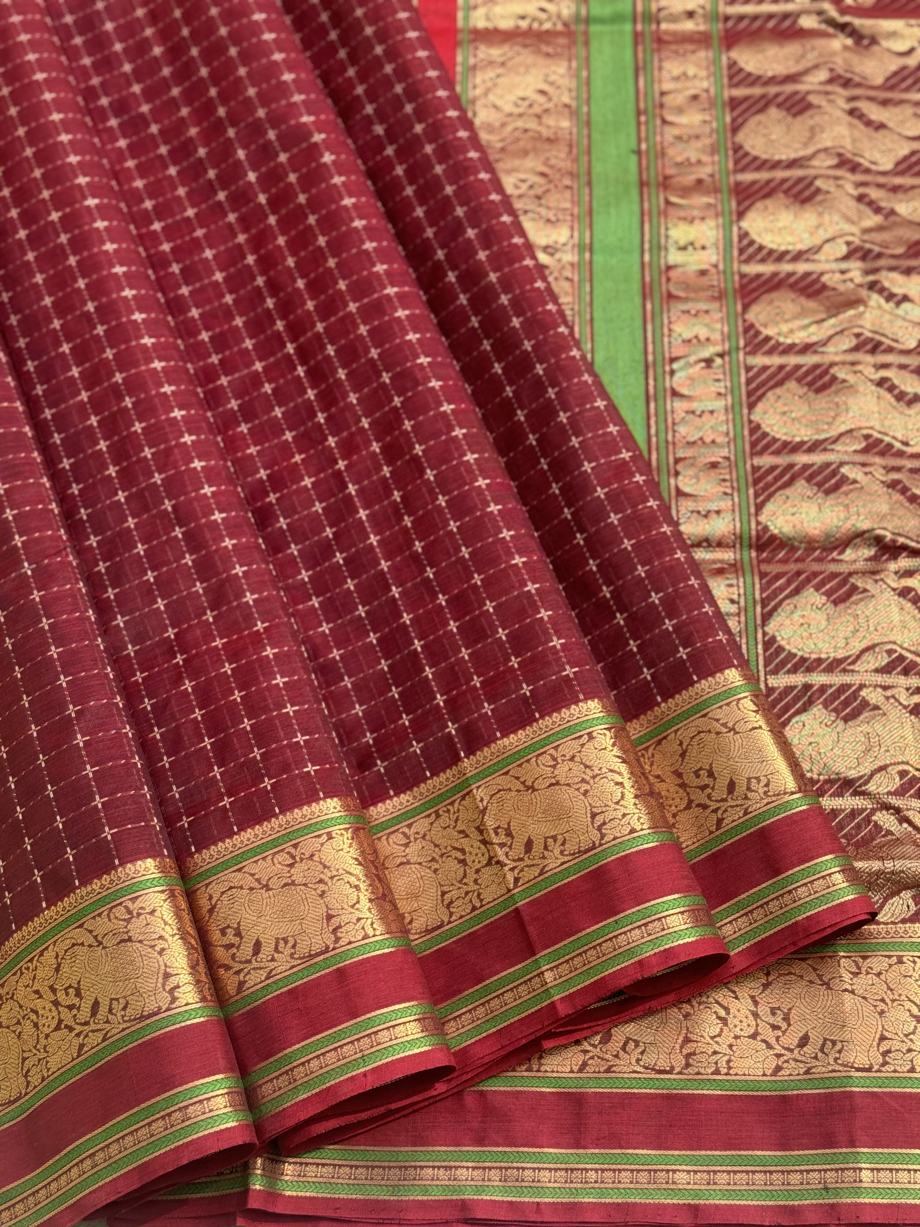 A gorgeous burgundy shade handwoven plus buttas silk cotton saree