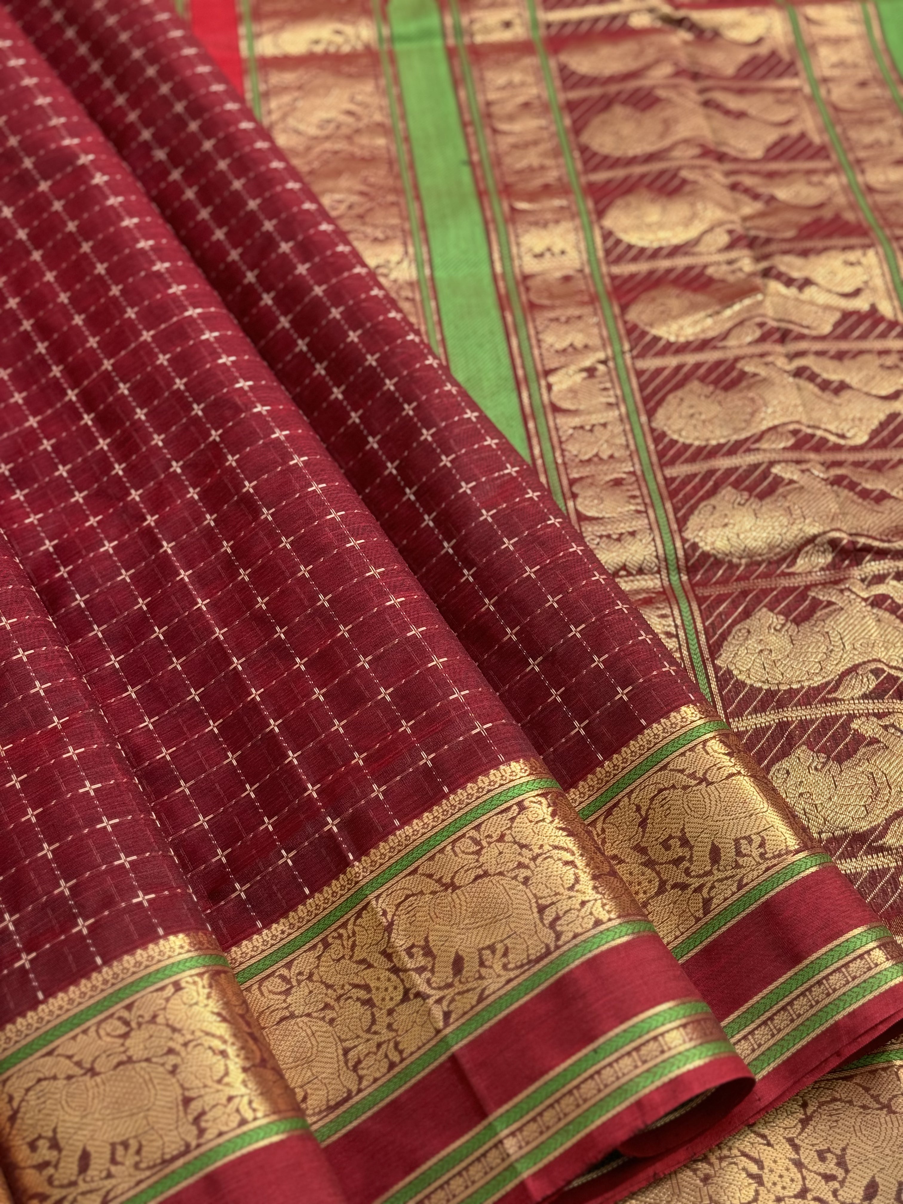 A gorgeous burgundy shade handwoven plus buttas silk cotton saree