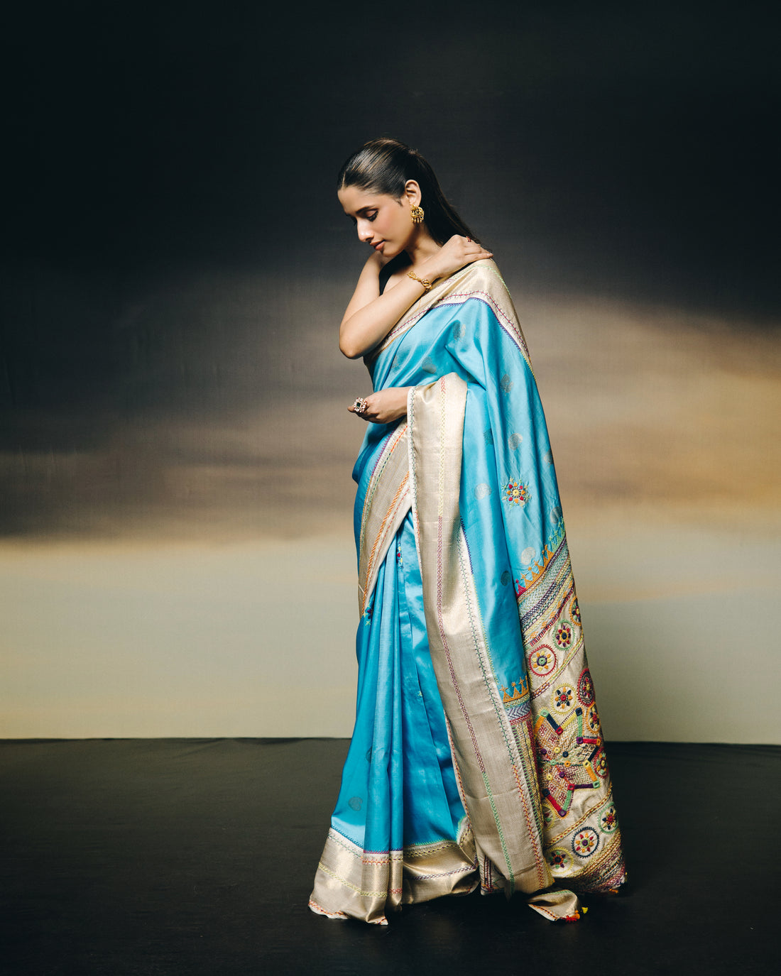 handwoven pure kanchivaram silk saree with korvai borders adorned with an exquisite handmade lambani mirror work