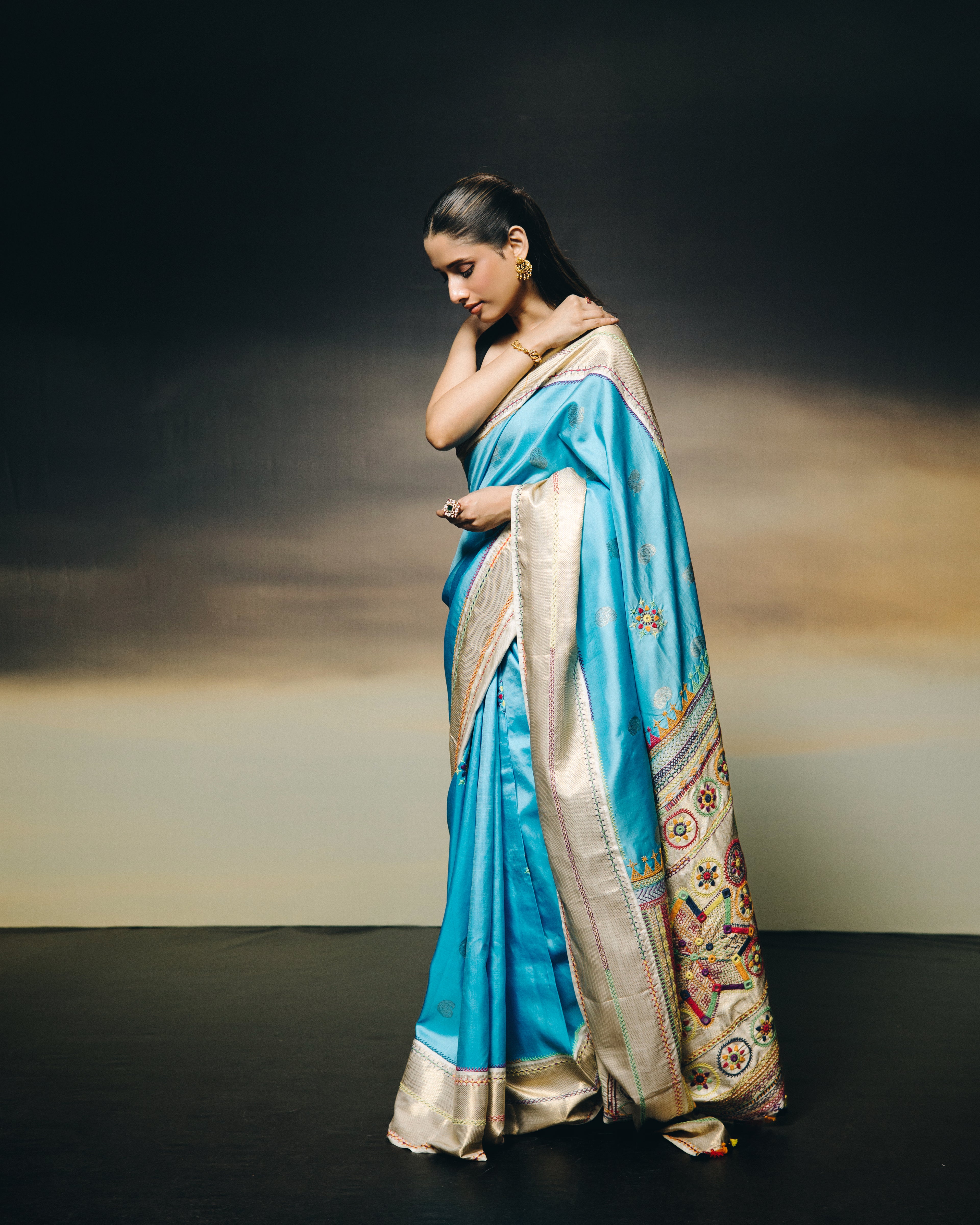 handwoven pure kanchivaram silk saree with korvai borders adorned with an exquisite handmade lambani mirror work