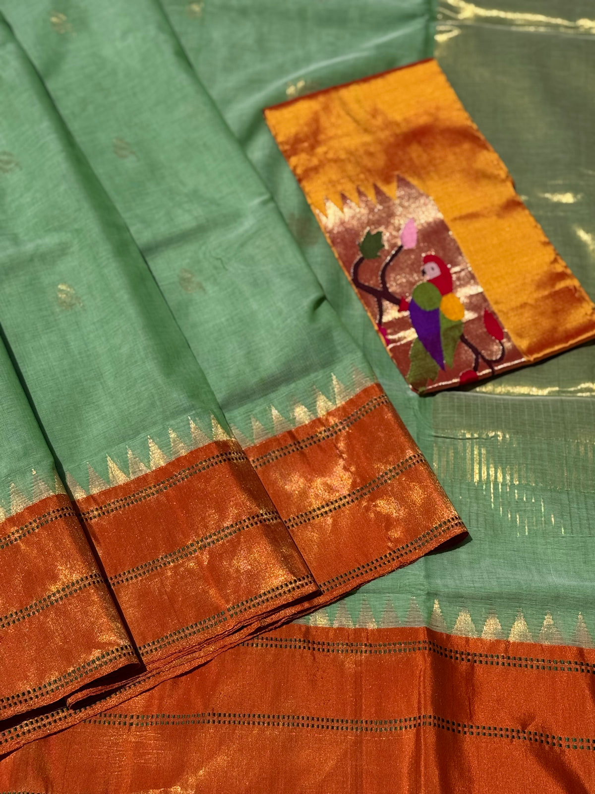 A gorgeous sage green with orange shade handspun ponduru Khadhi jamdani cotton saree