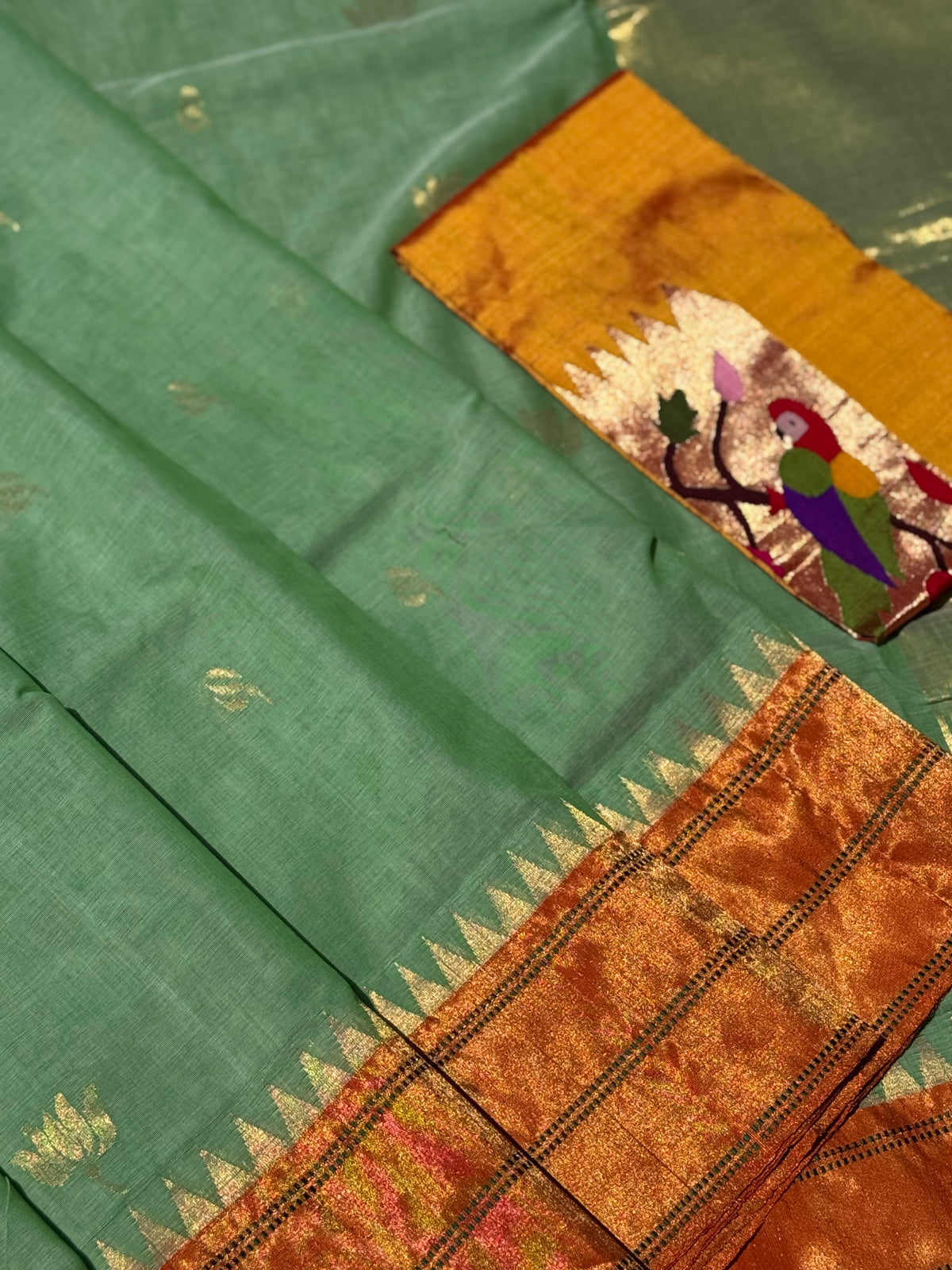 A gorgeous sage green with orange shade handspun ponduru Khadhi jamdani cotton saree