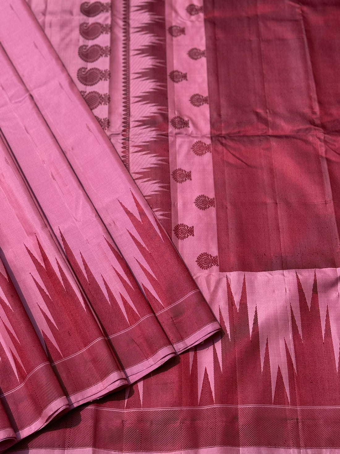 A gorgeous Pastel pink with plum shade handwoven soft and lustrous temple woven gadwal silk saree