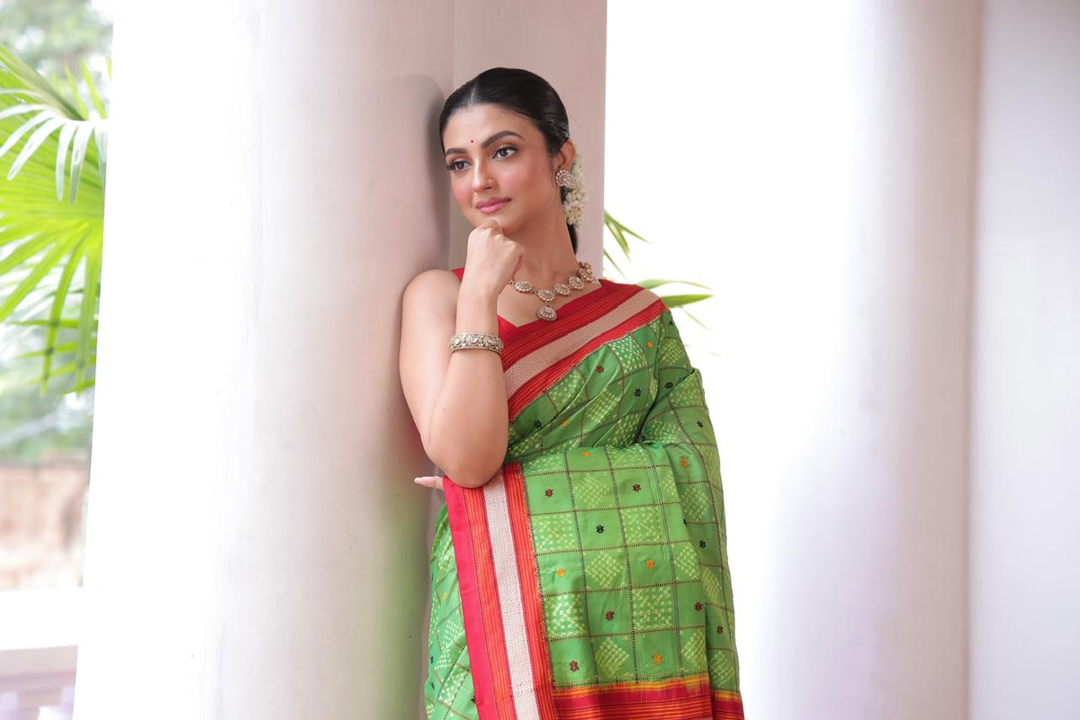 A Fern Green shade revival vintage recreated masterpiece created by a national award winning masterweaver, a highly skilled craftsmanship silk ikkat saree