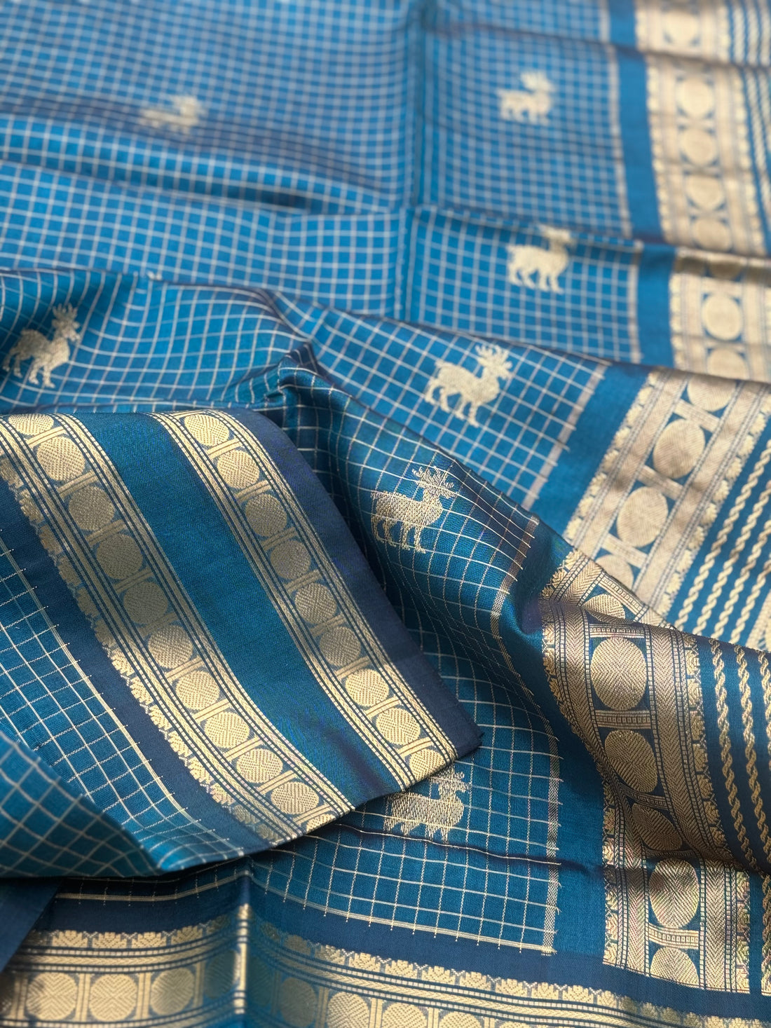 A gorgeous peacock blue shade handwoven zari checks with deer motifs Kanchi silk cotton saree