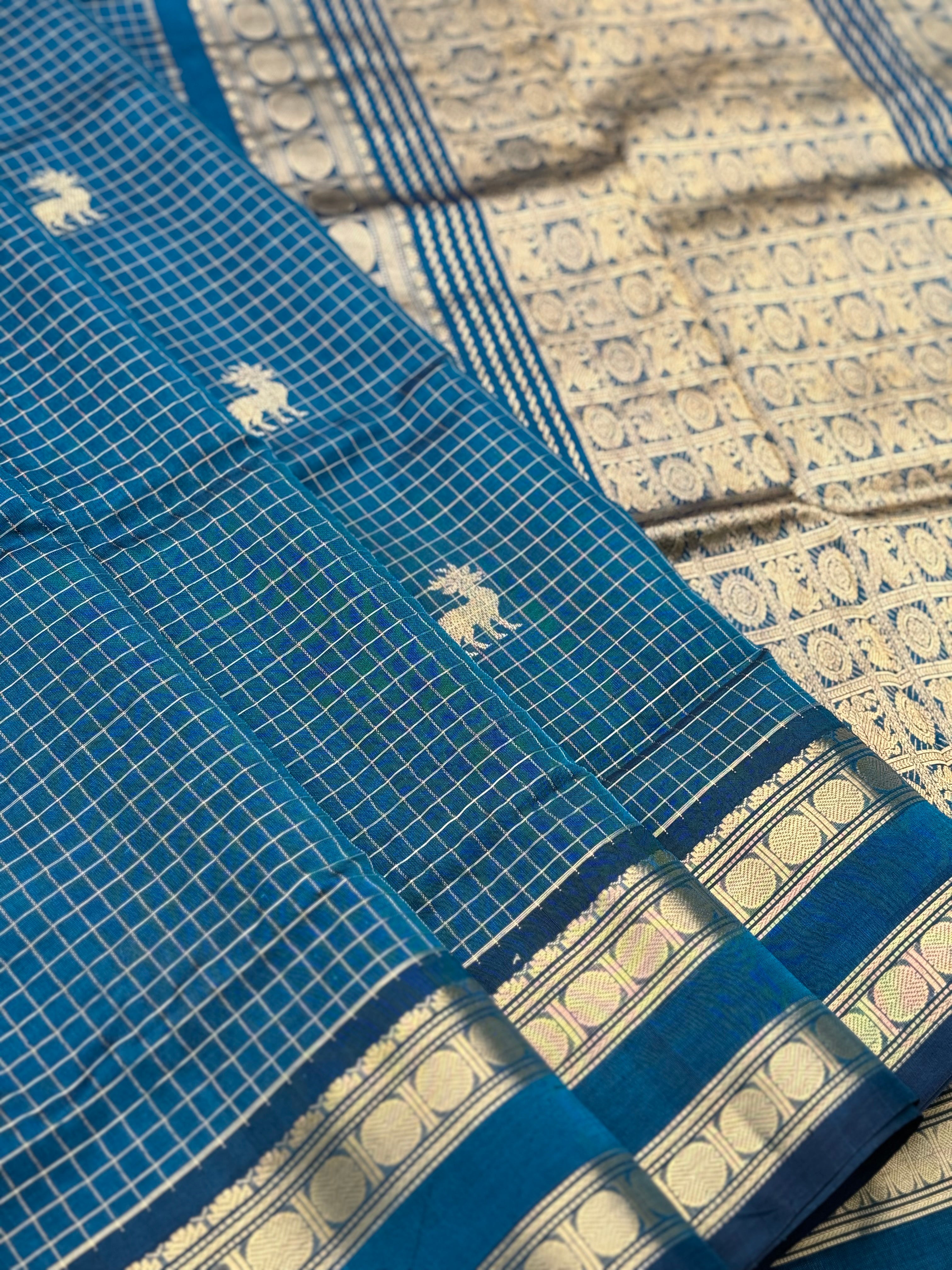 A gorgeous peacock blue shade handwoven zari checks with deer motifs Kanchi silk cotton saree