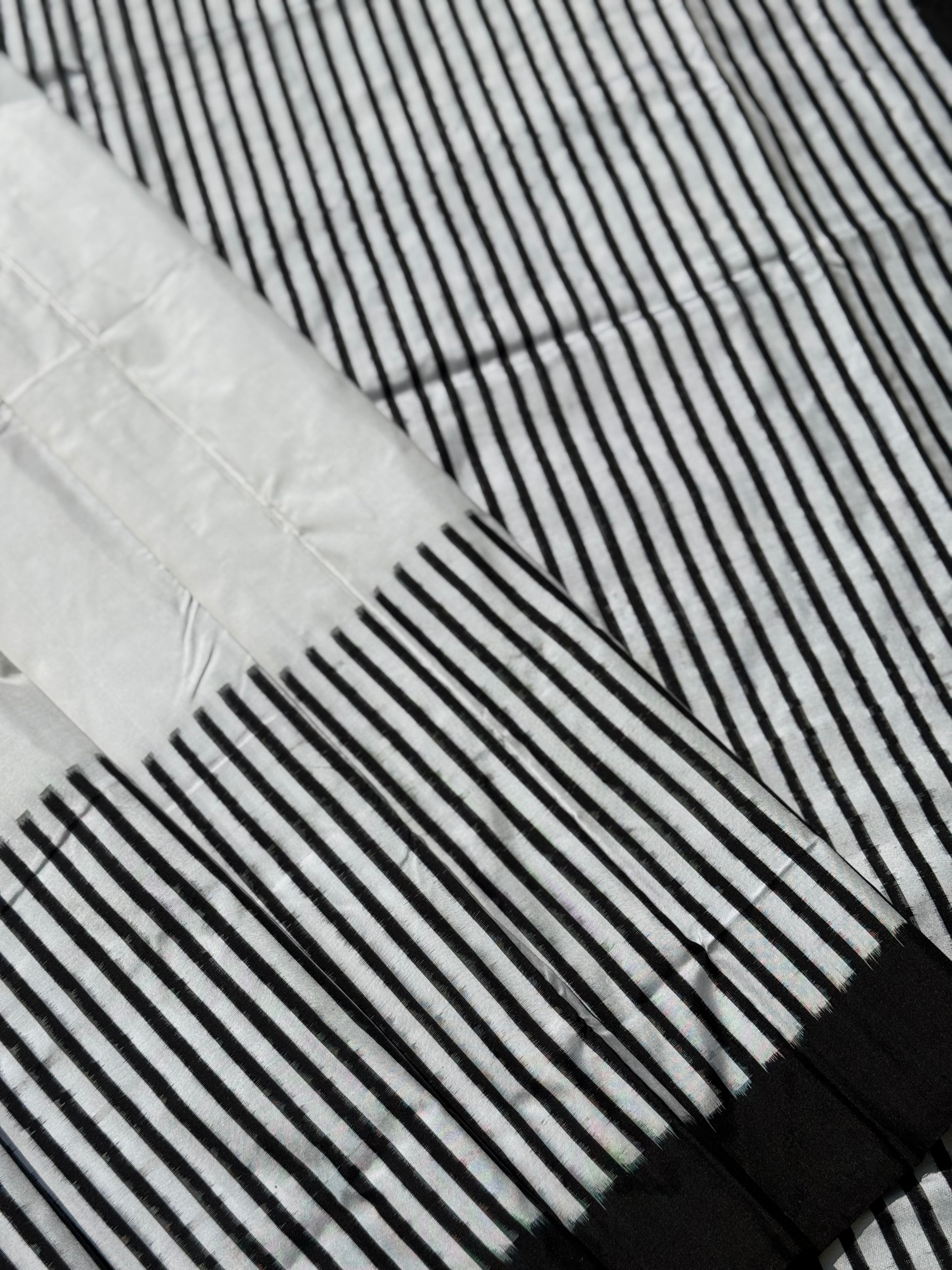 A double warp and weft tie dyed ikkat handwoven saree in pure mulberry silk with contemporary style of design