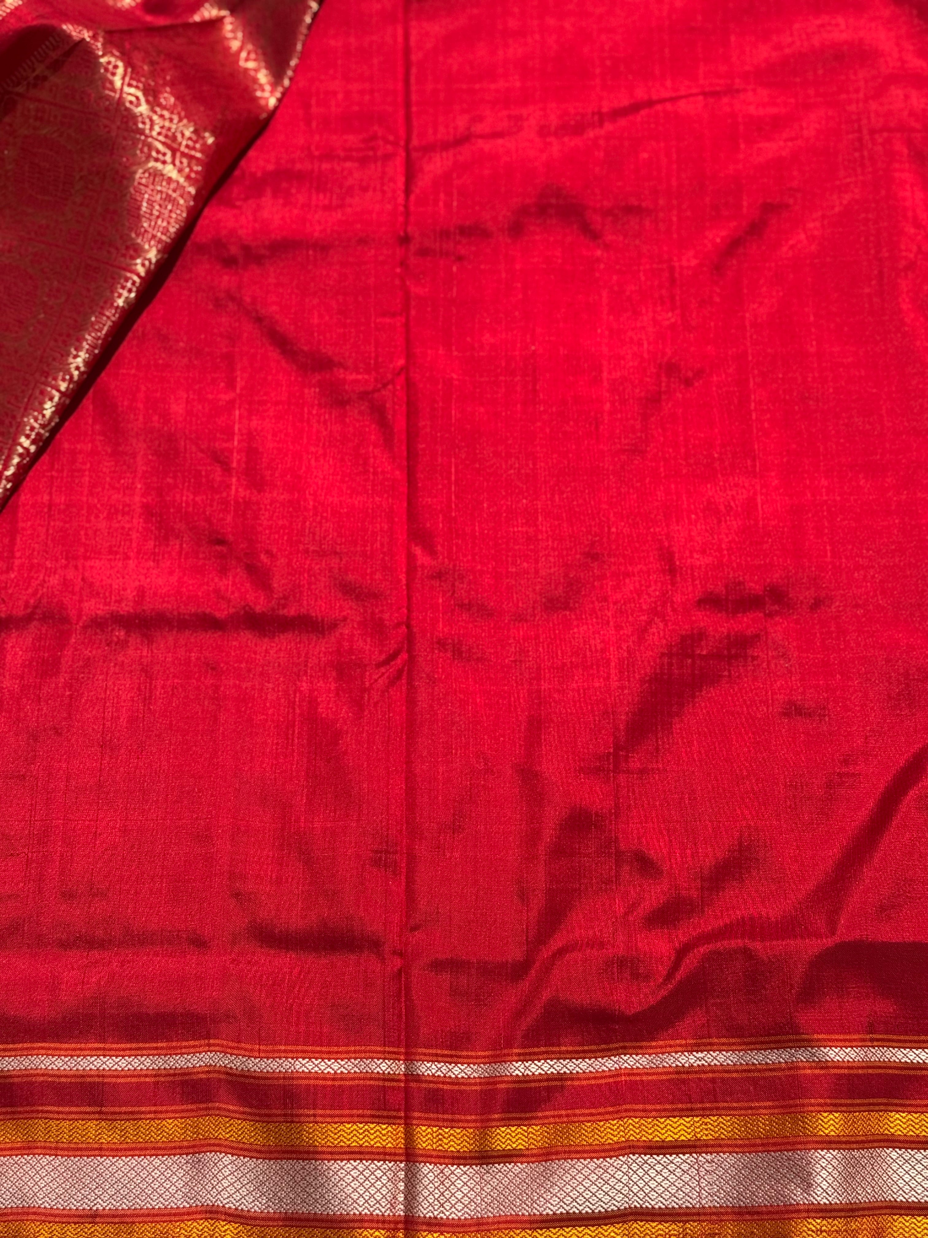 A masterpiece piece red shade weft single ikkat tie dyed handwoven saree in pure mulberry silk with traditional checks