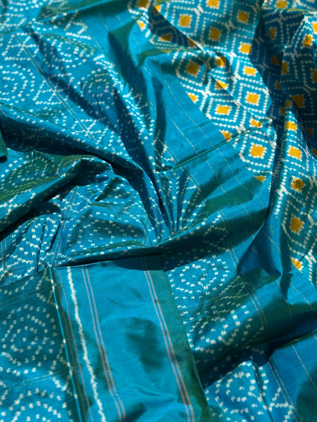 A masterpiece ikkat handwoven weft ikkat saree in pure mulberry silk in teal shade with complete zari checks on body