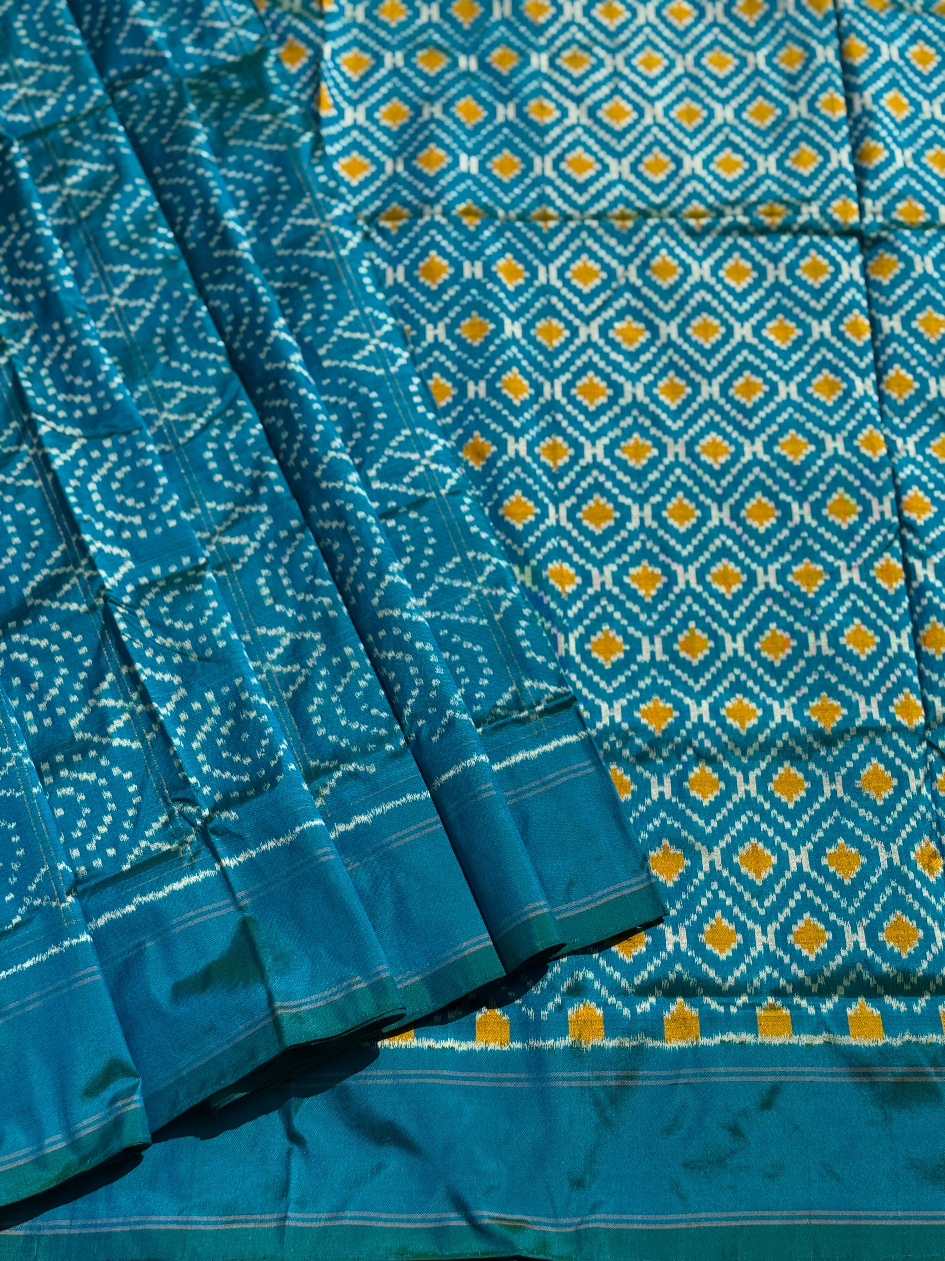 A masterpiece ikkat handwoven weft ikkat saree in pure mulberry silk in teal shade with complete zari checks on body