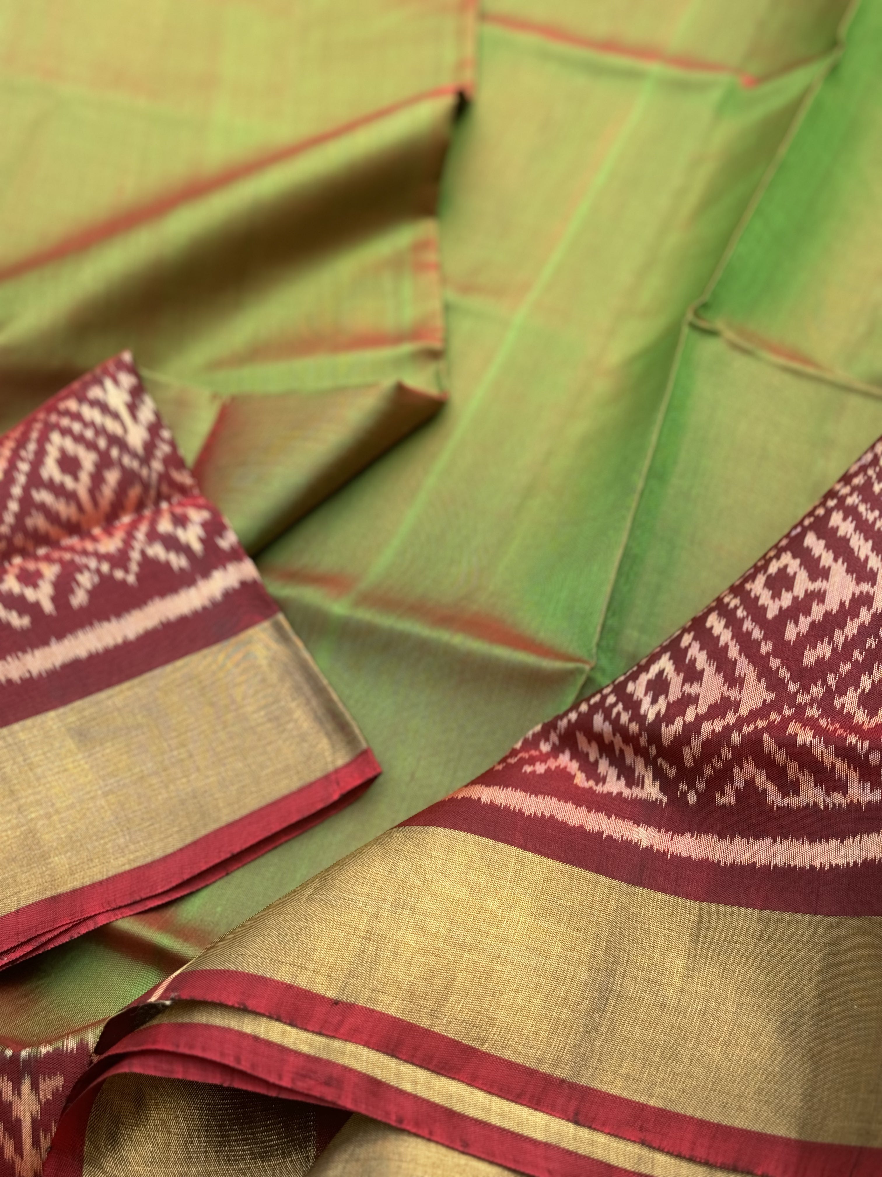 A gorgeous tender leaf green with maroon shade single ikkat patola silk Saree