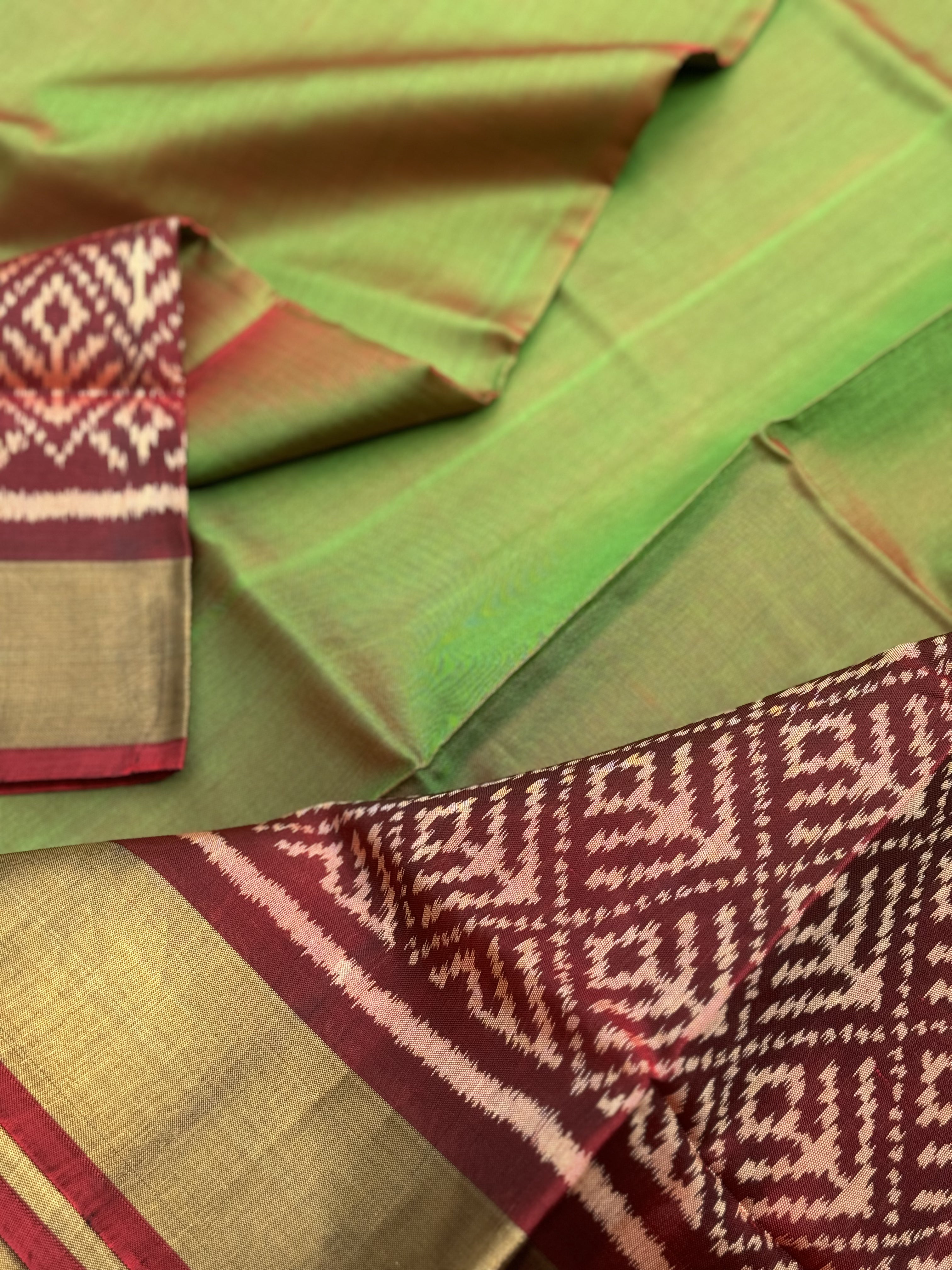 A gorgeous tender leaf green with maroon shade single ikkat patola silk Saree