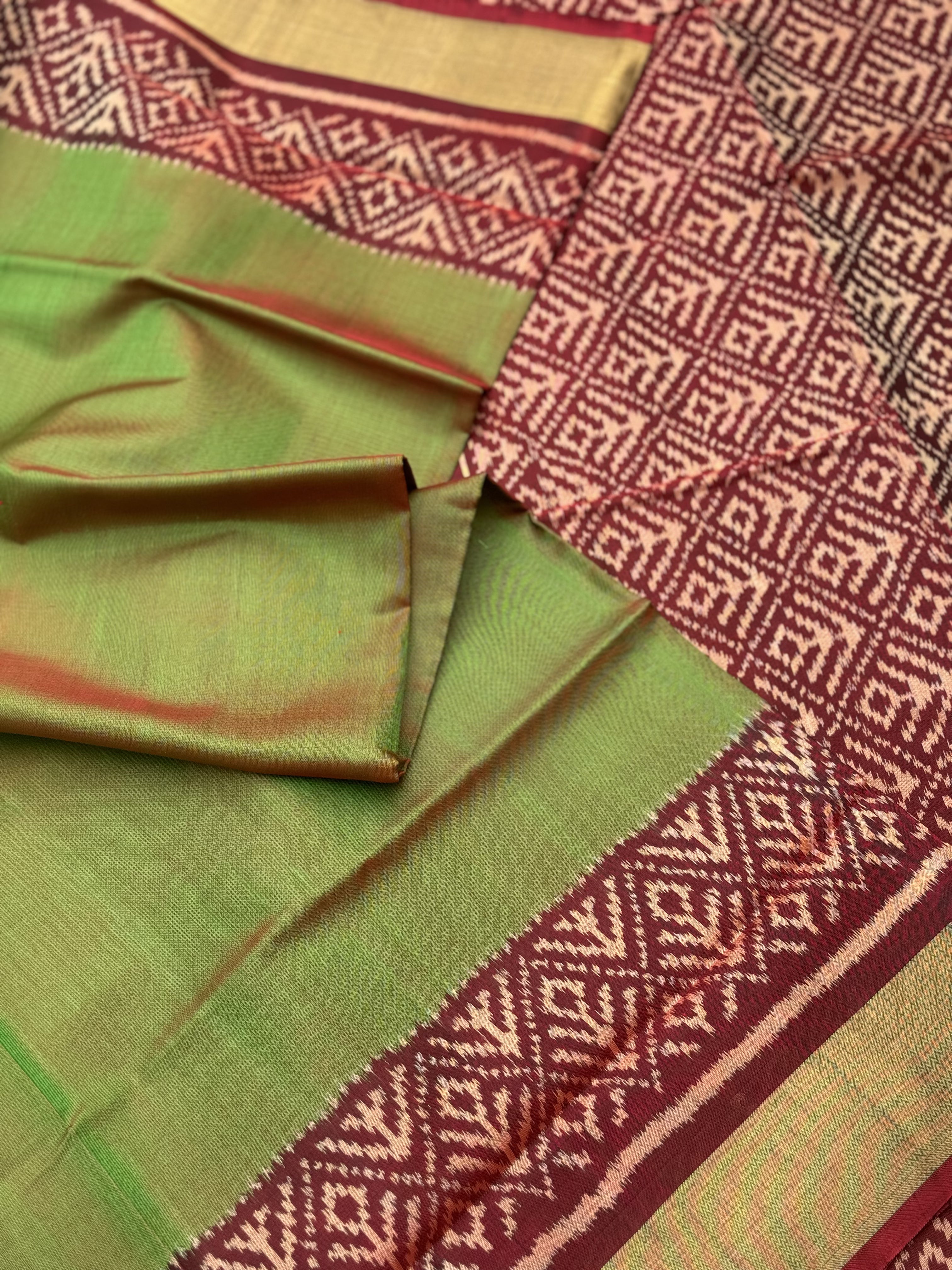 A gorgeous tender leaf green with maroon shade single ikkat patola silk Saree