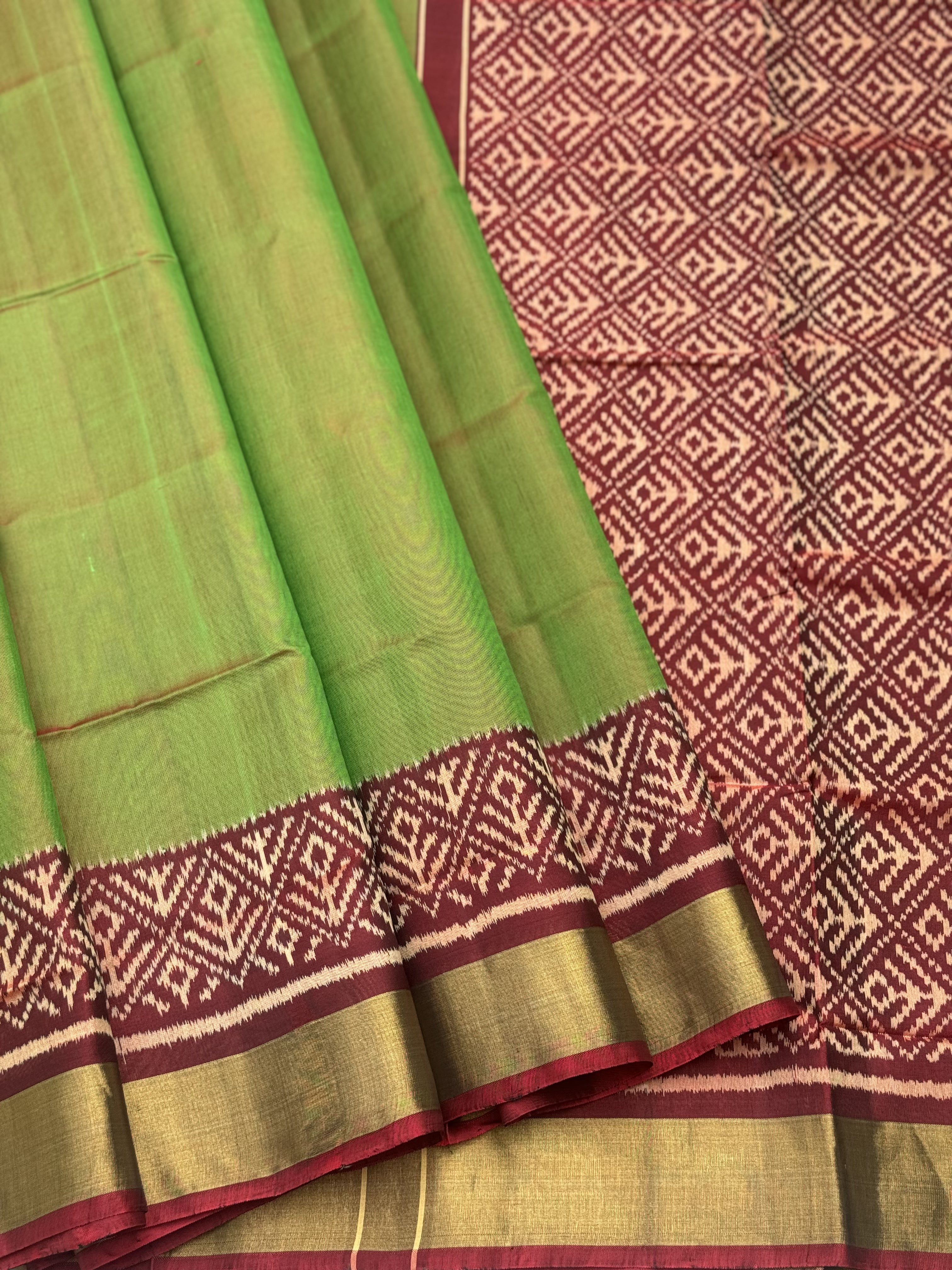 A gorgeous tender leaf green with maroon shade single ikkat patola silk Saree