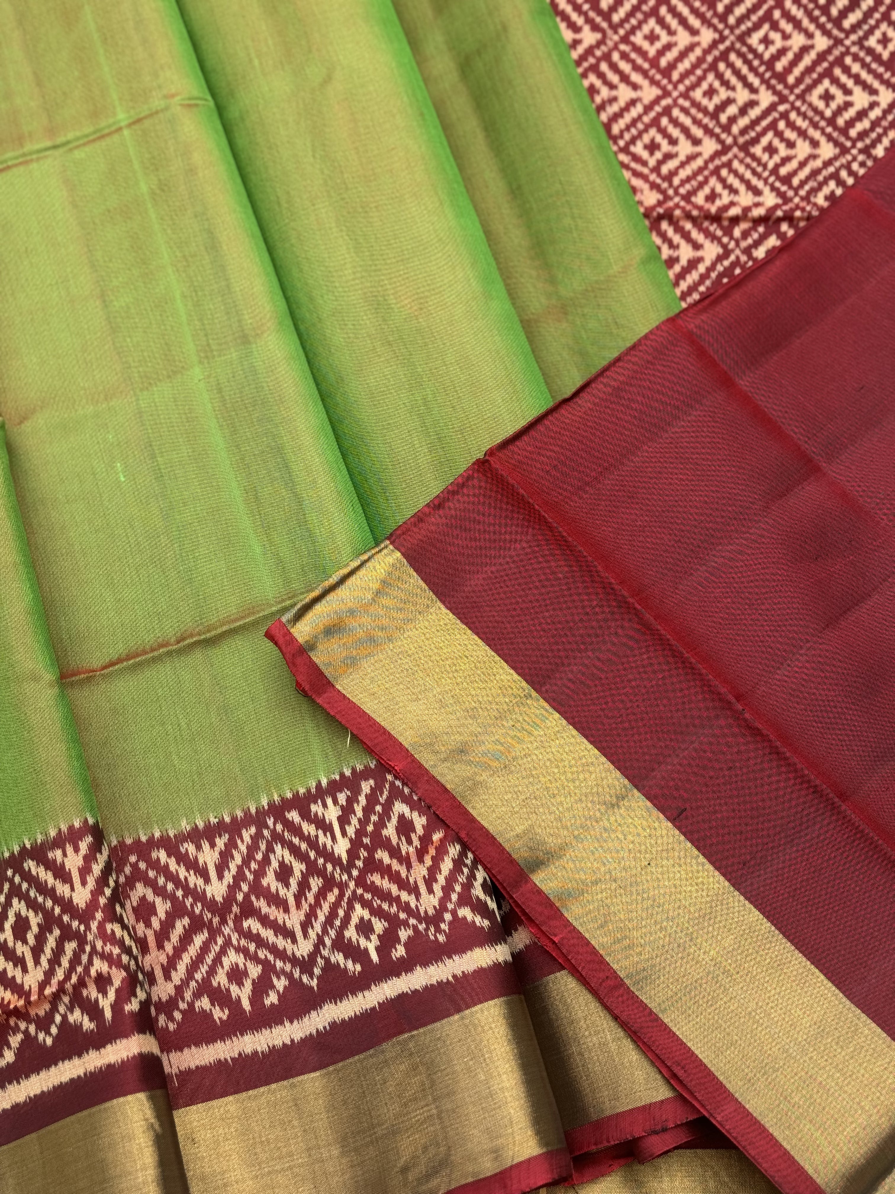 A gorgeous tender leaf green with maroon shade single ikkat patola silk Saree