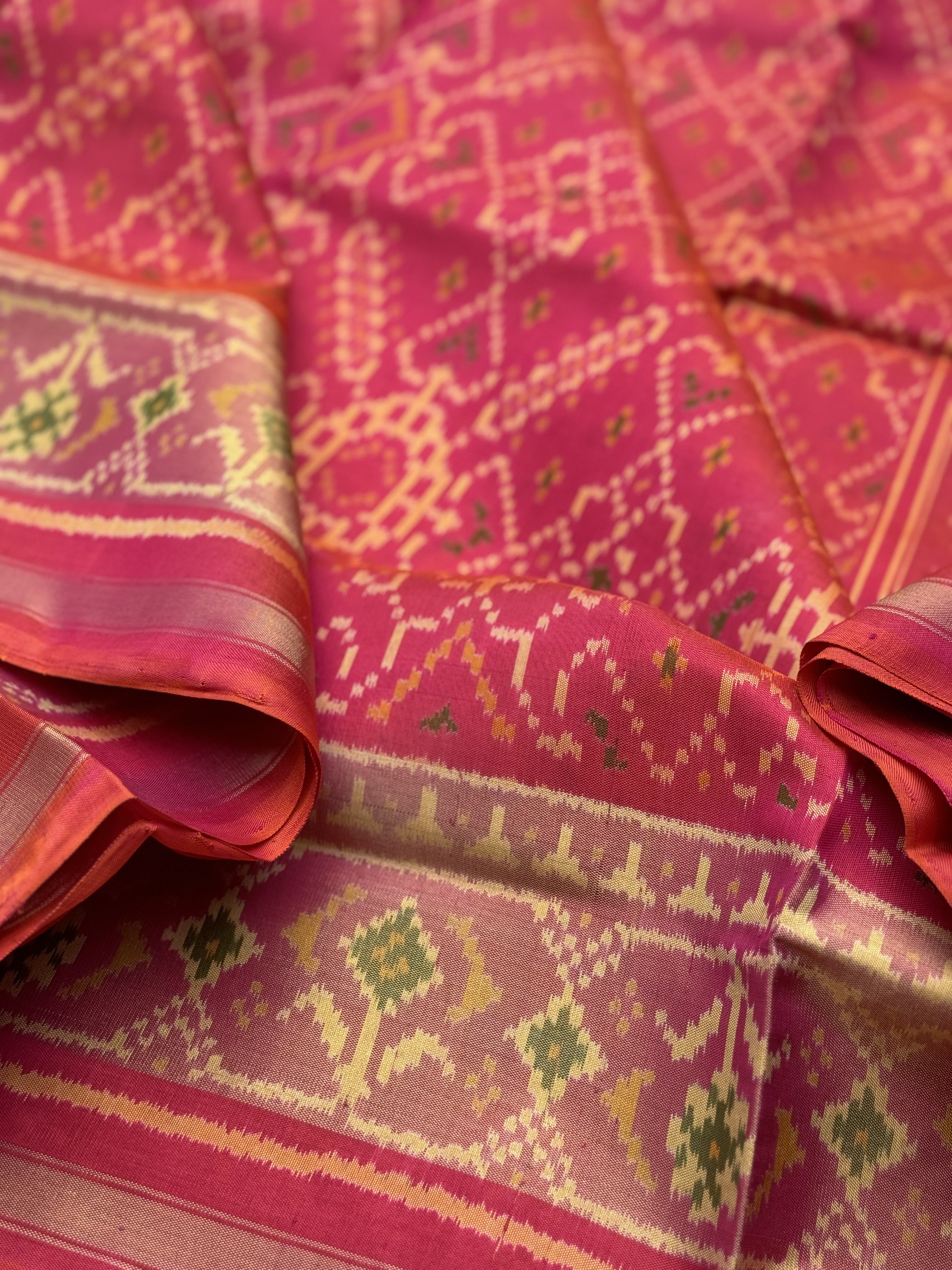 A gorgeous Peachish pink shade single ikkat patola silk Saree