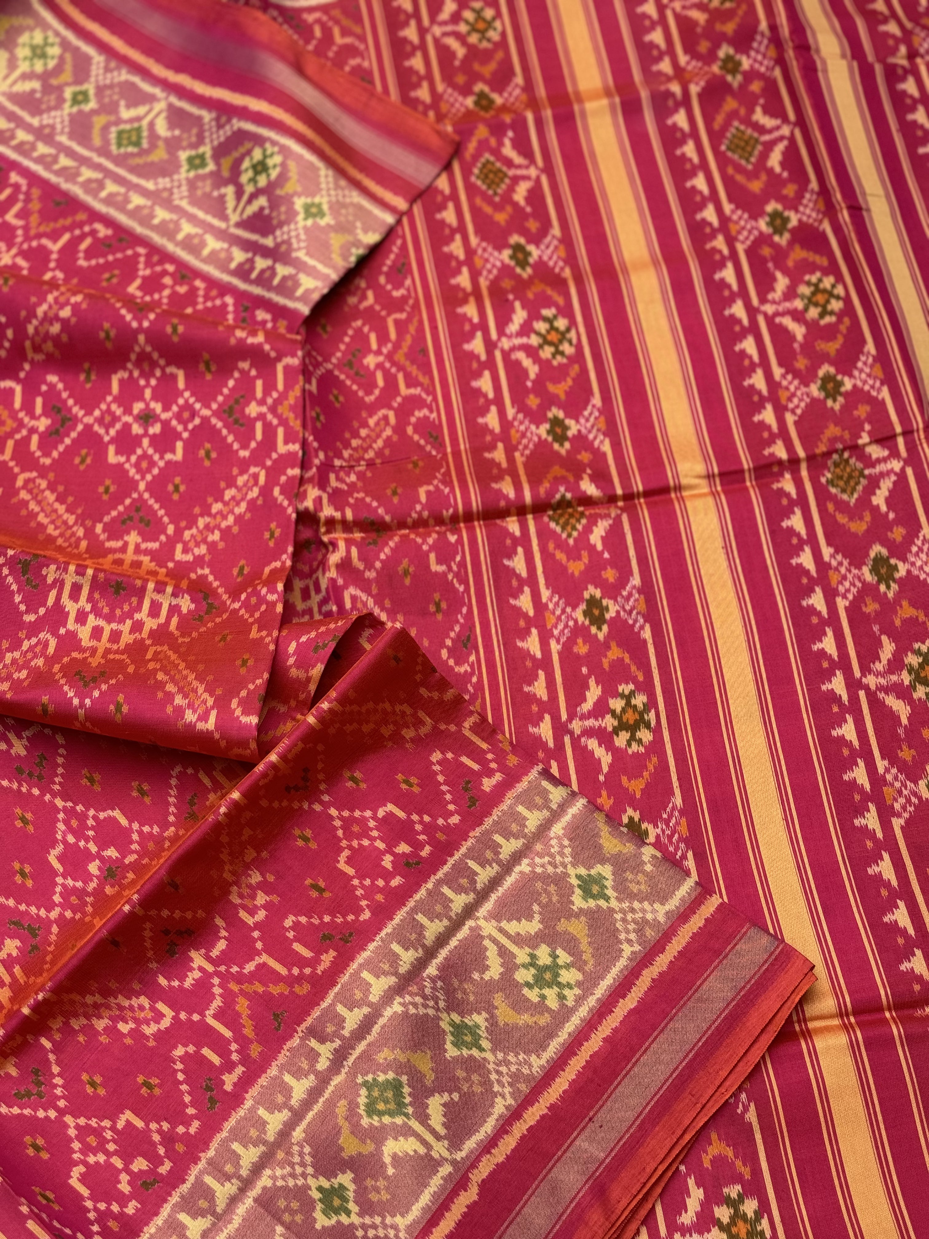 A gorgeous Peachish pink shade single ikkat patola silk Saree