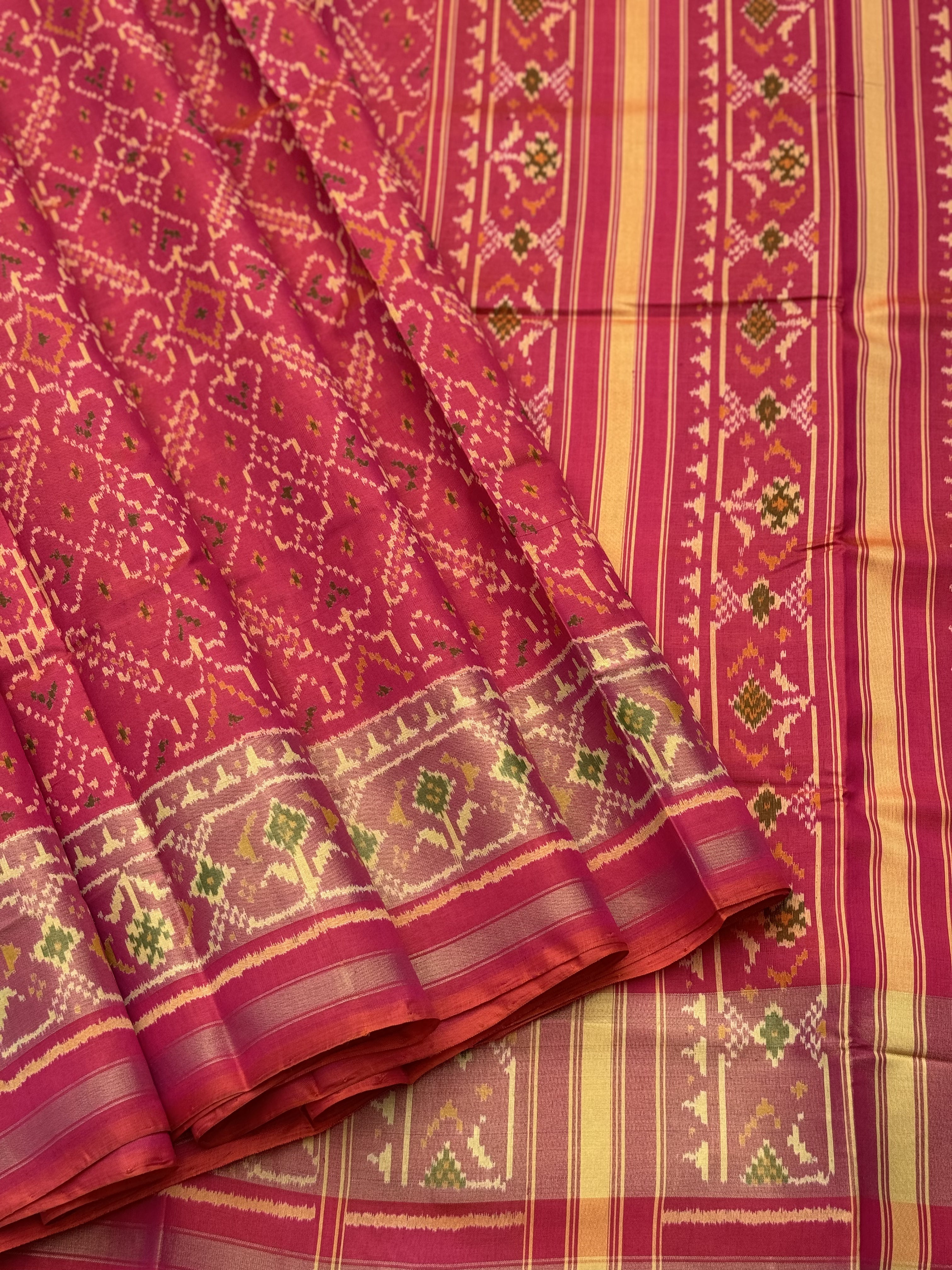 A gorgeous Peachish pink shade single ikkat patola silk Saree