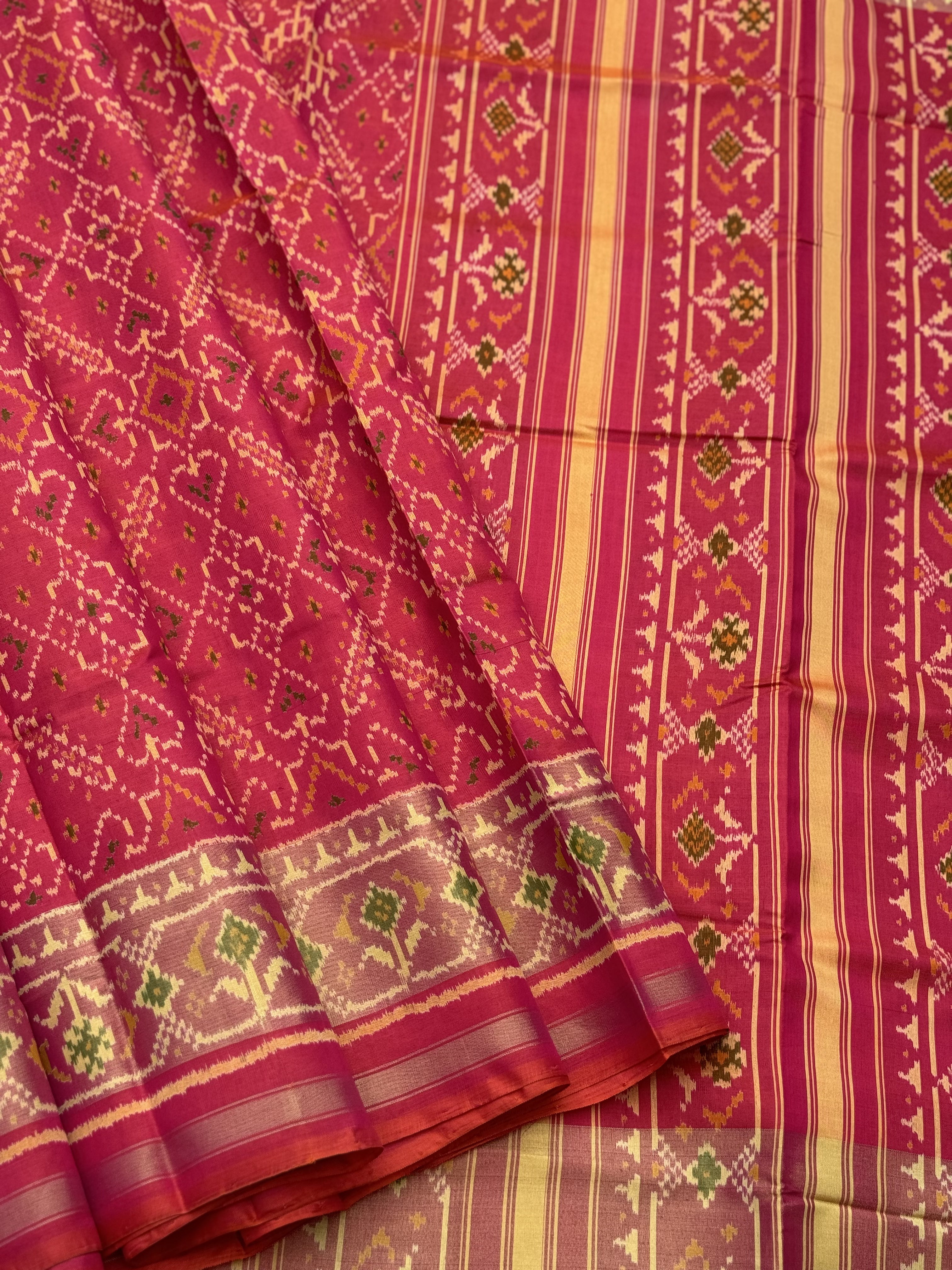 A gorgeous Peachish pink shade single ikkat patola silk Saree