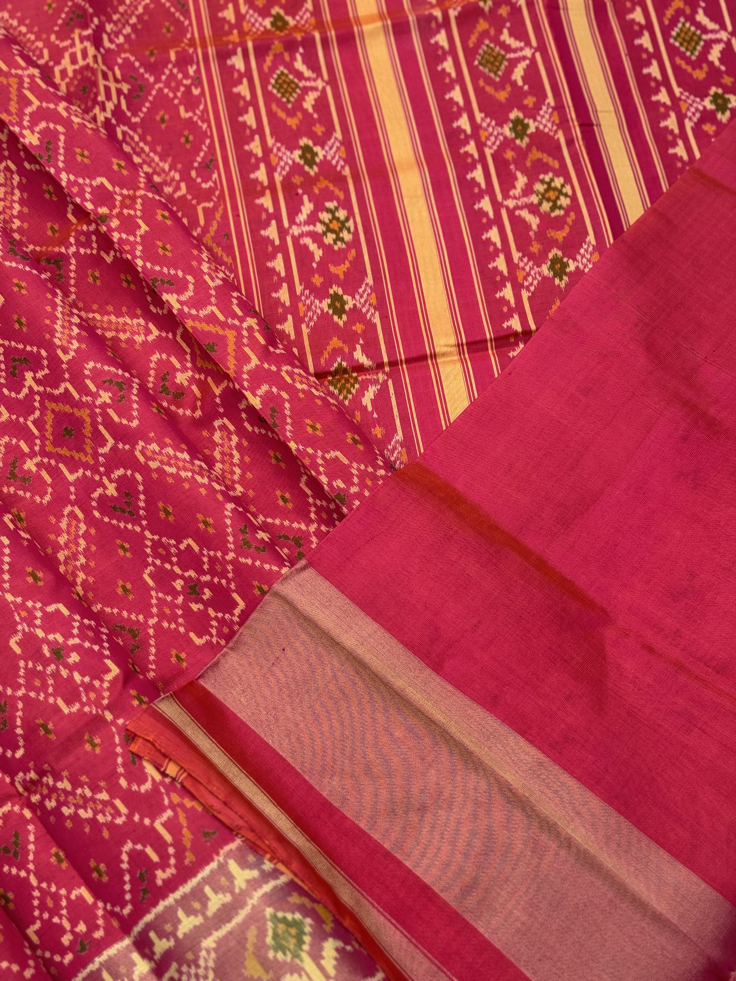 A gorgeous Peachish pink shade single ikkat patola silk Saree