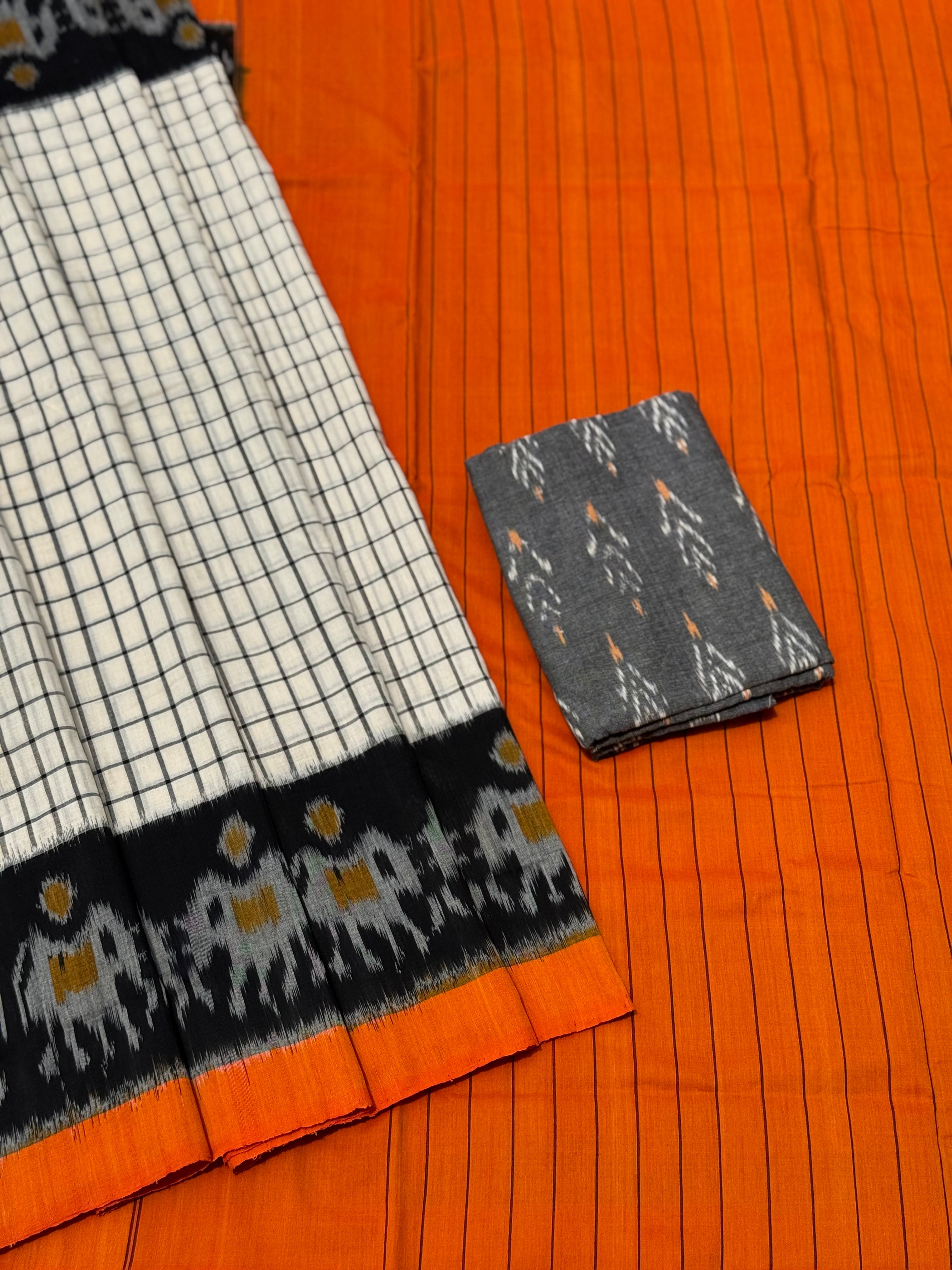 White checks with orange black handwoven weft single ikkat cotton saree