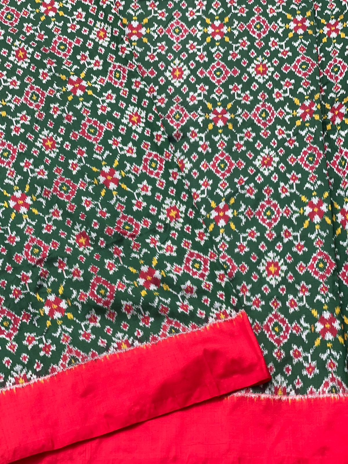 Bottle green Patola Navrathan inspired ikkat design on mulberry silk