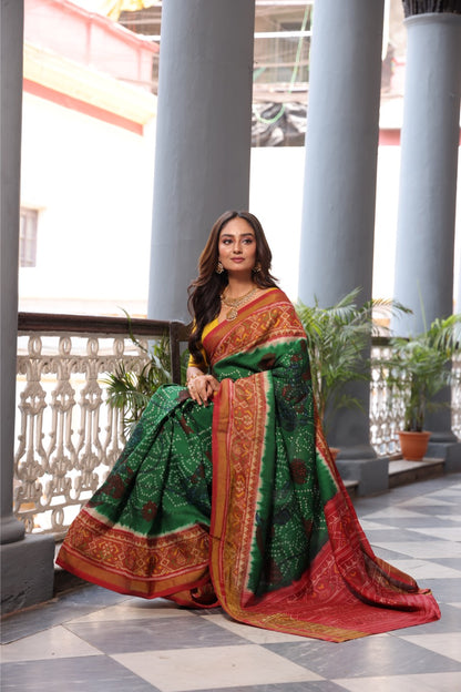 THARAGAI - Handknotted tie dyed Bhandej Ikkat silk saree with hand drawn and handpainted Penkanamkari Saree