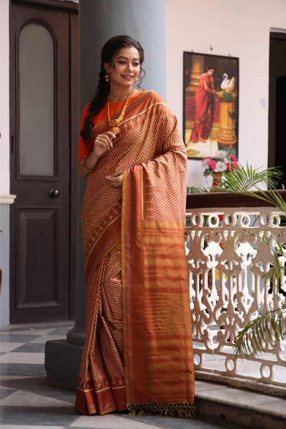 Natural Dye Silk Ikkat Saree In Lehariya Pattern In rustic orange with muted Gold Shade