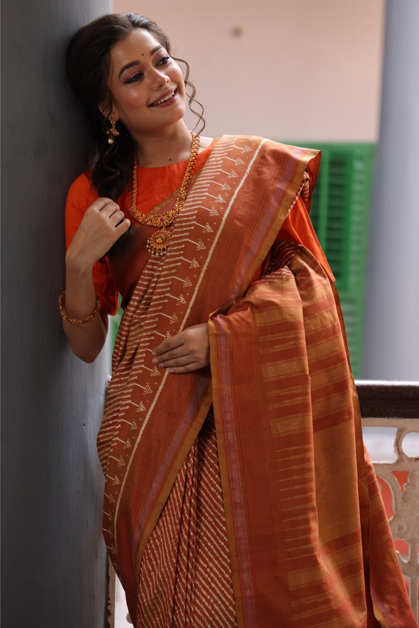 Natural Dye Silk Ikkat Saree In Lehariya Pattern In rustic orange with muted Gold Shade