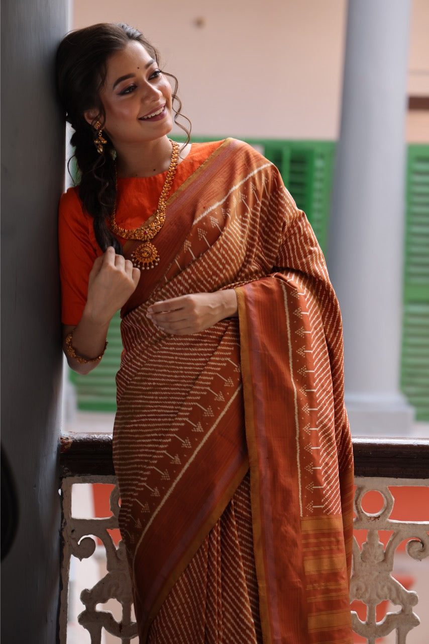 Natural Dye Silk Ikkat Saree In Lehariya Pattern In rustic orange with muted Gold Shade