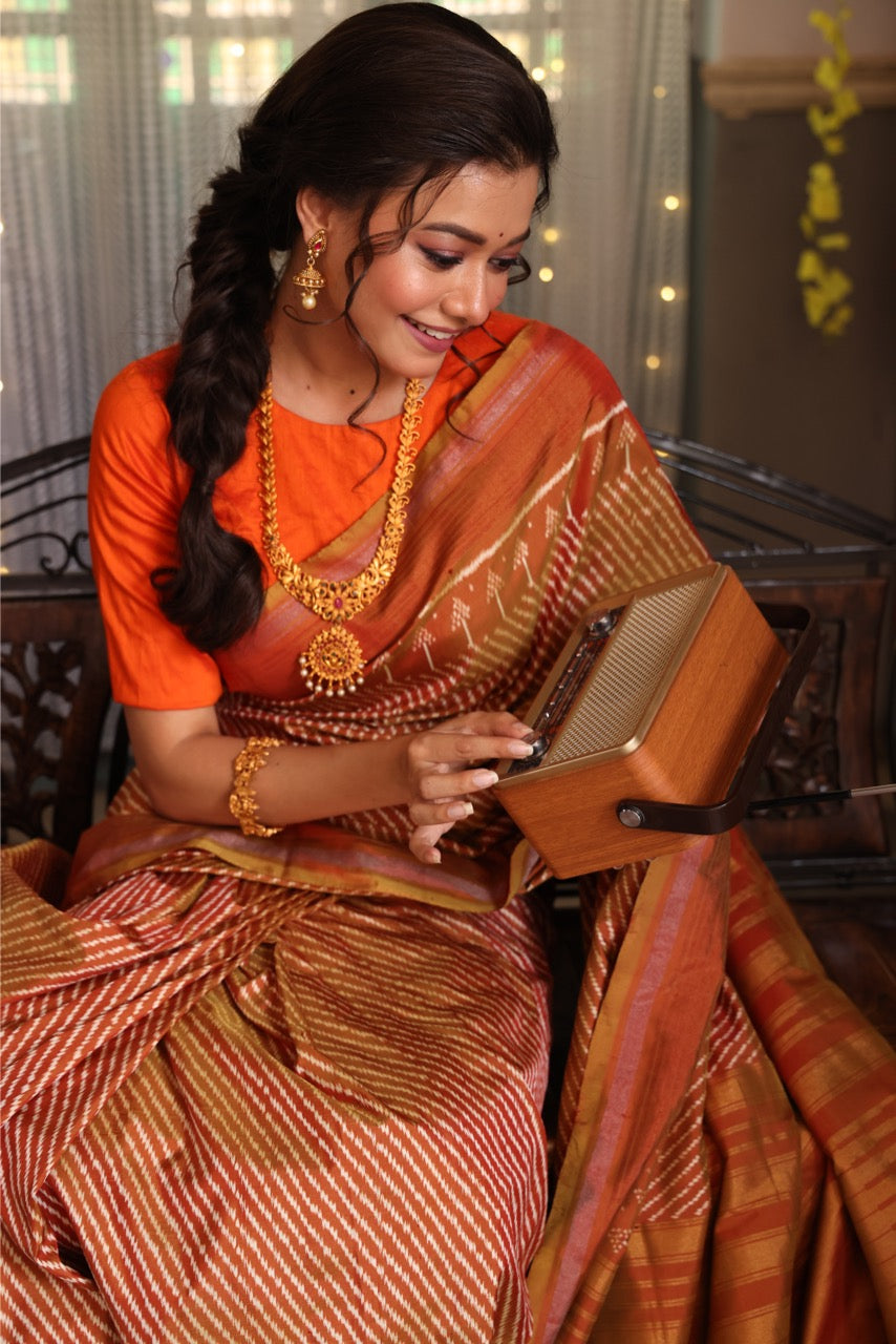 Natural Dye Silk Ikkat Saree In Lehariya Pattern In rustic orange with muted Gold Shade