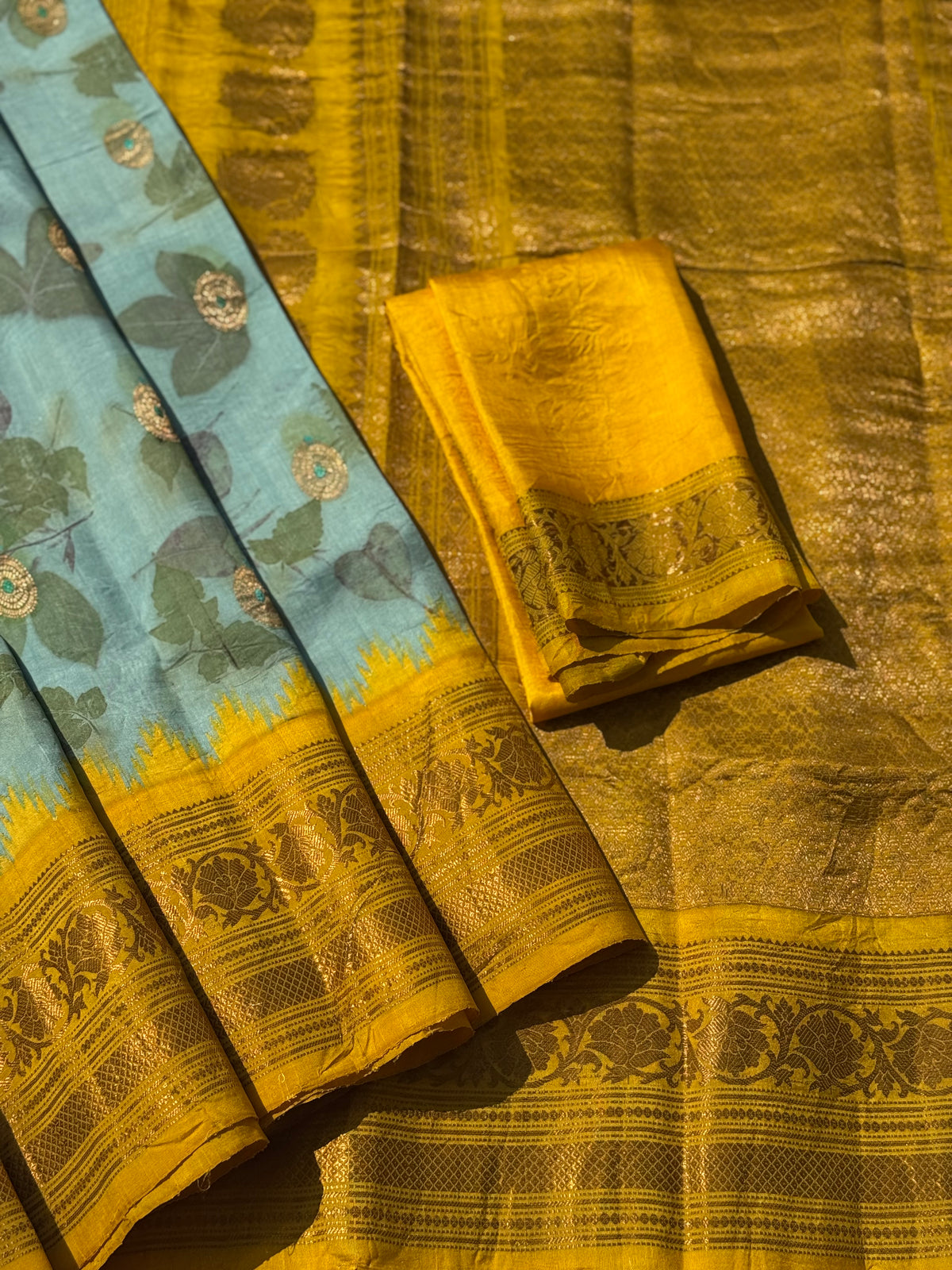 A gorgeous natural ecoprints done on pastel mint green with yellow kuttu gadwal silk saree