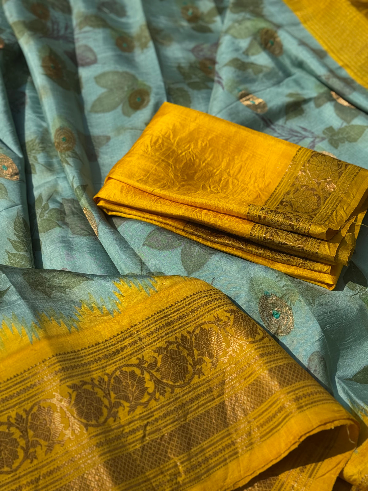 A gorgeous natural ecoprints done on pastel mint green with yellow kuttu gadwal silk saree
