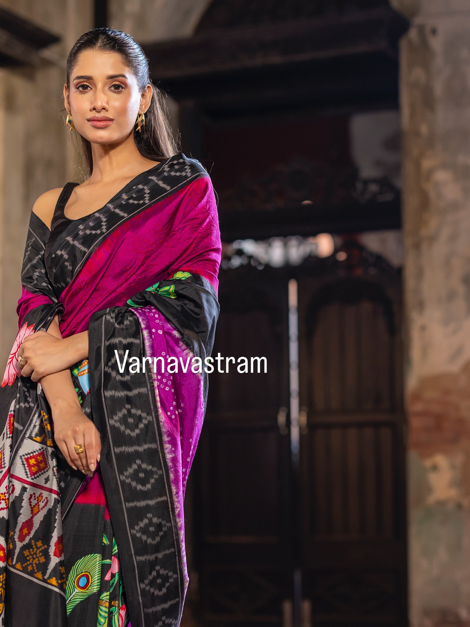 An elegant fusion crafted mulberry silk ikkat saree adorned with pichwai handpainted and tie dyed Bhandej