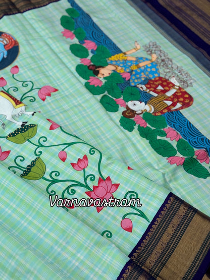 A stunner kanchivaram kattam korvai silk saree with foam green adorned with Handdrawn handpainted pichwai artwork