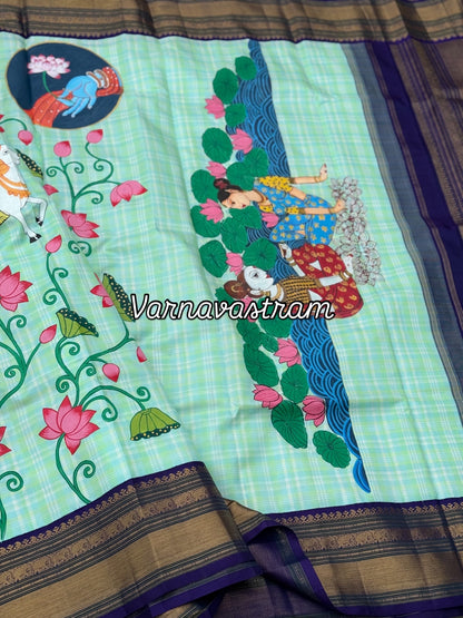 A stunner kanchivaram kattam korvai silk saree with foam green adorned with Handdrawn handpainted pichwai artwork