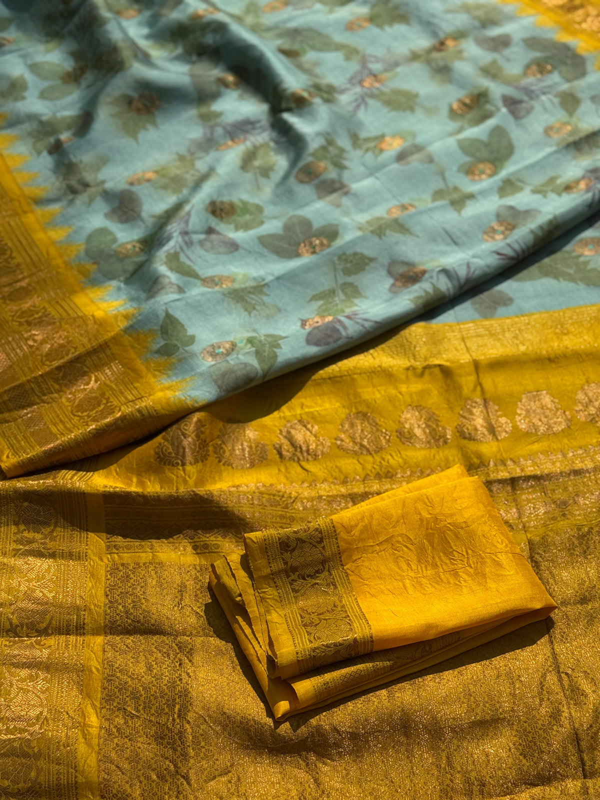 A gorgeous natural ecoprints done on pastel mint green with yellow kuttu gadwal silk saree