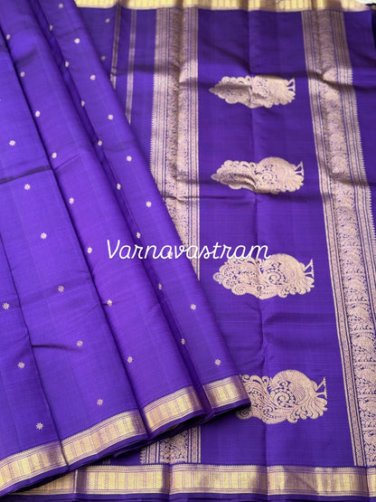 An elegant small border purple blue shade kanchivaram silk saree with star kamalam