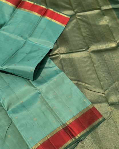 A gorgeous cyan green with red threadwork and zari border kanchivaram silk SAREE