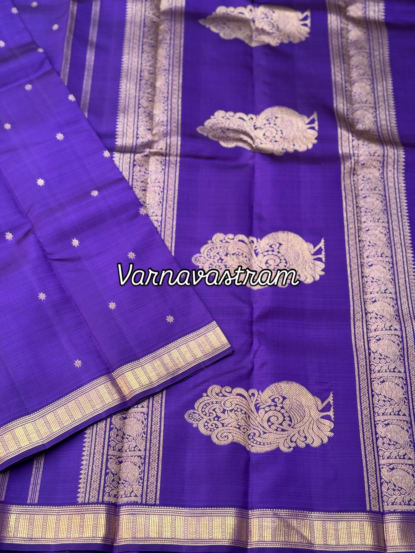 An elegant small border purple blue shade kanchivaram silk saree with star kamalam